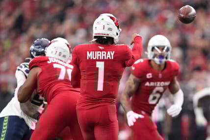 Kyler Murray throwing a pass to James Conner during a Cardinals game against the Seahawks