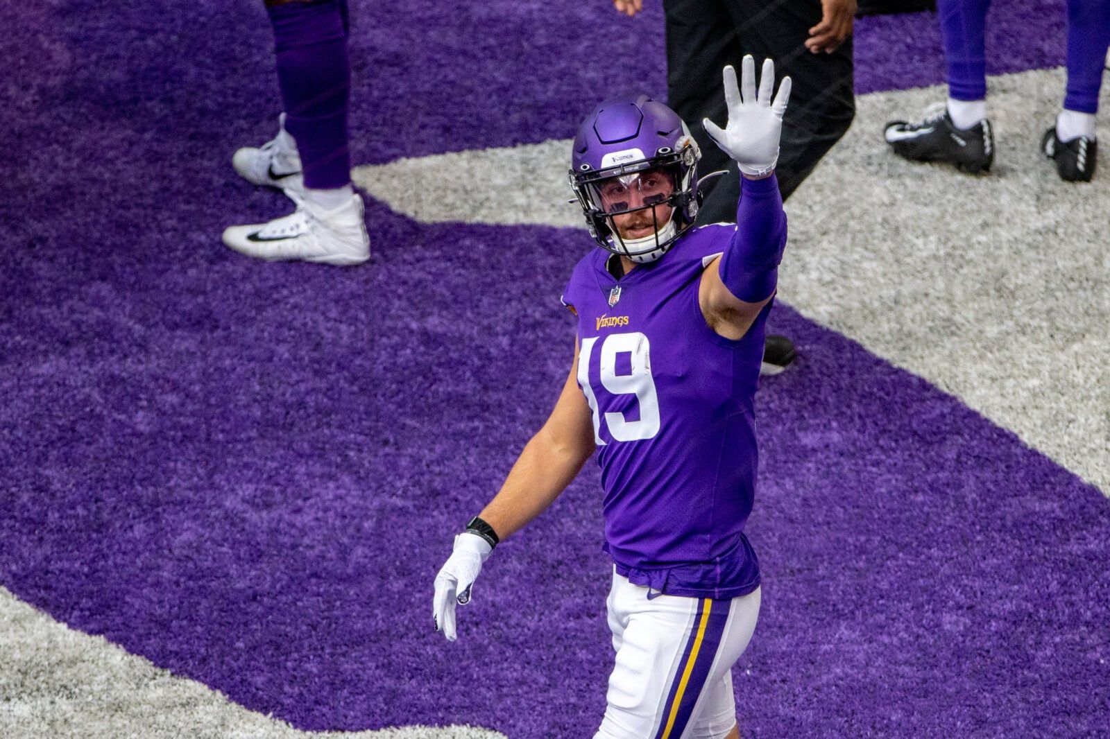 Adam Thielen waves toward empty seats before the game against Green Bay.