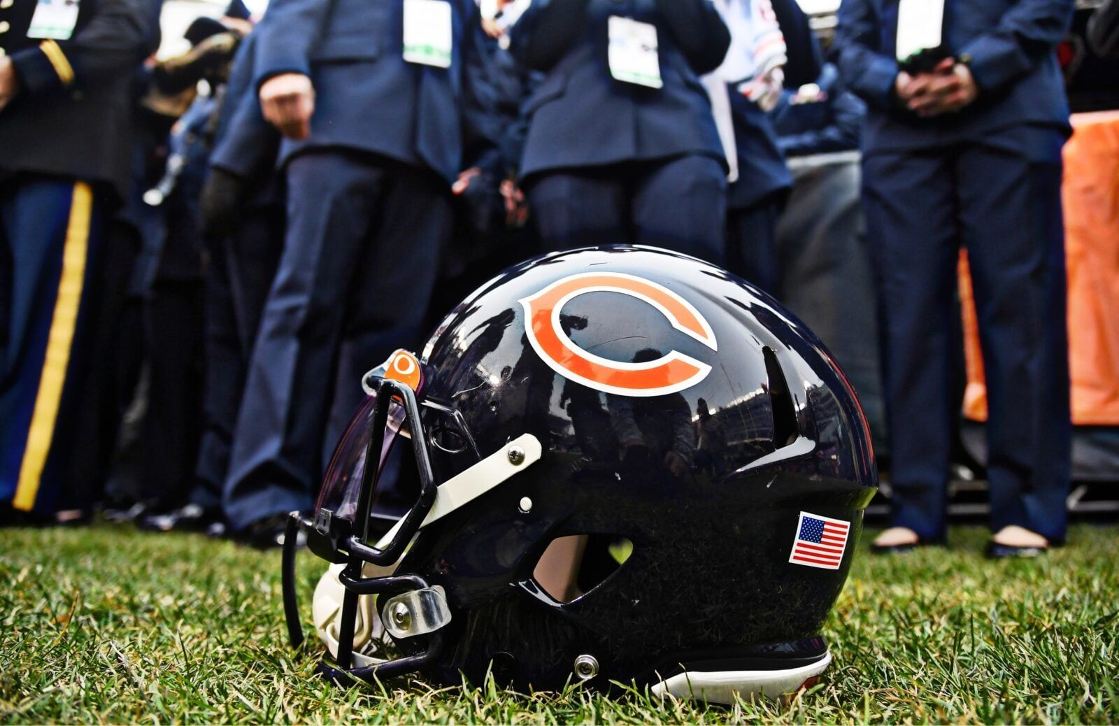 Close-up of a Chicago Bears helmet displaying the navy shell and orange logo before a game.