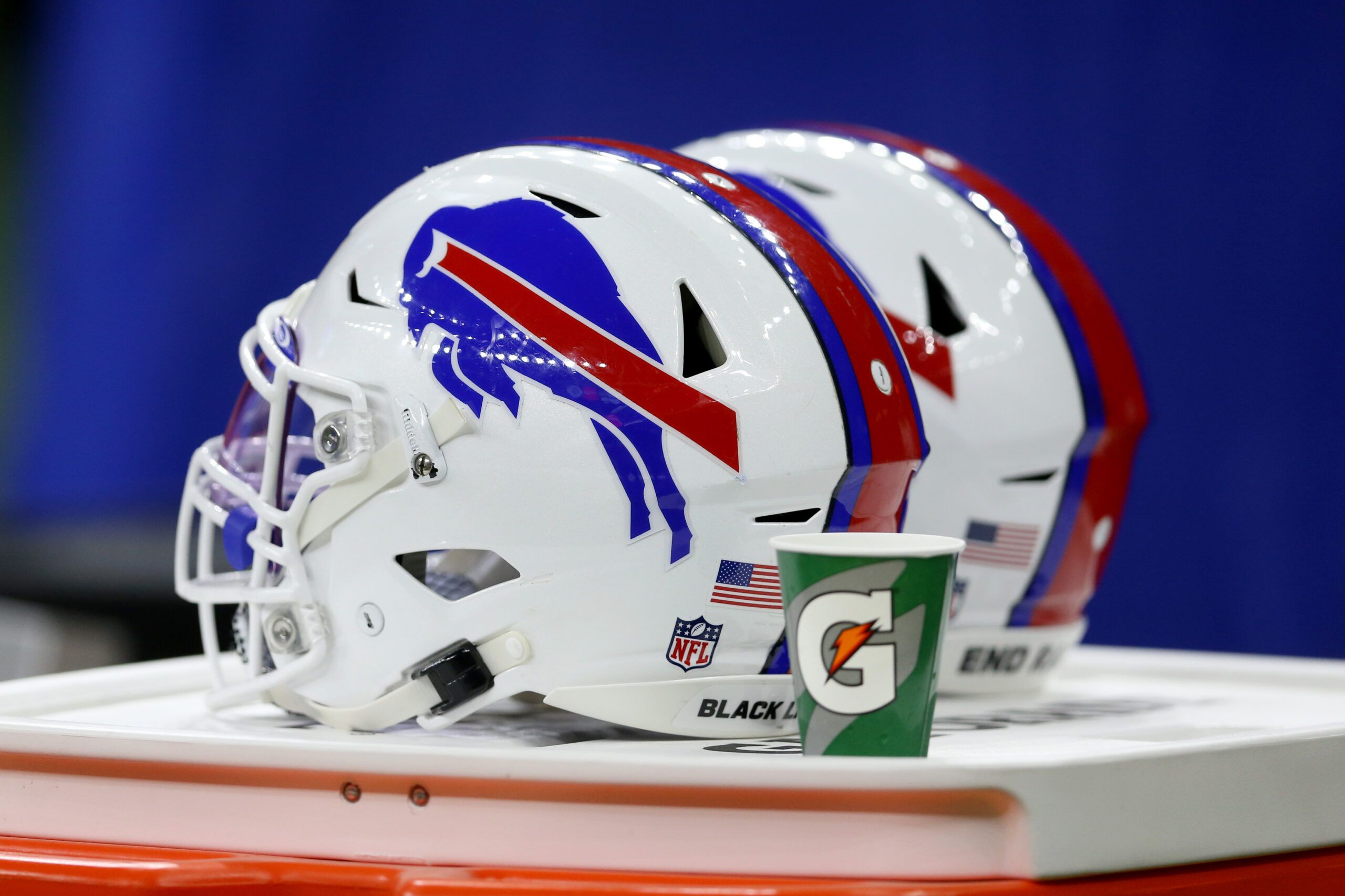 Buffalo Bills helmets lined up on the sideline during a game against the Saints.