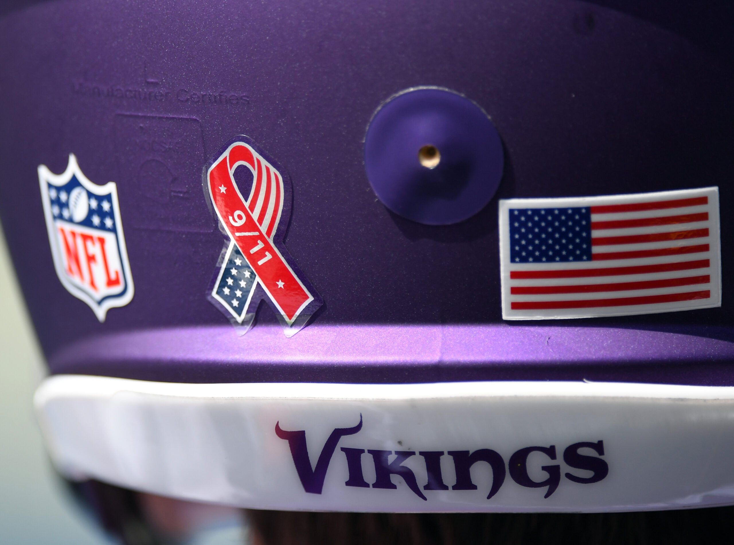 Close-up of a Vikings helmet with a 9/11 decal before a game against the Titans.