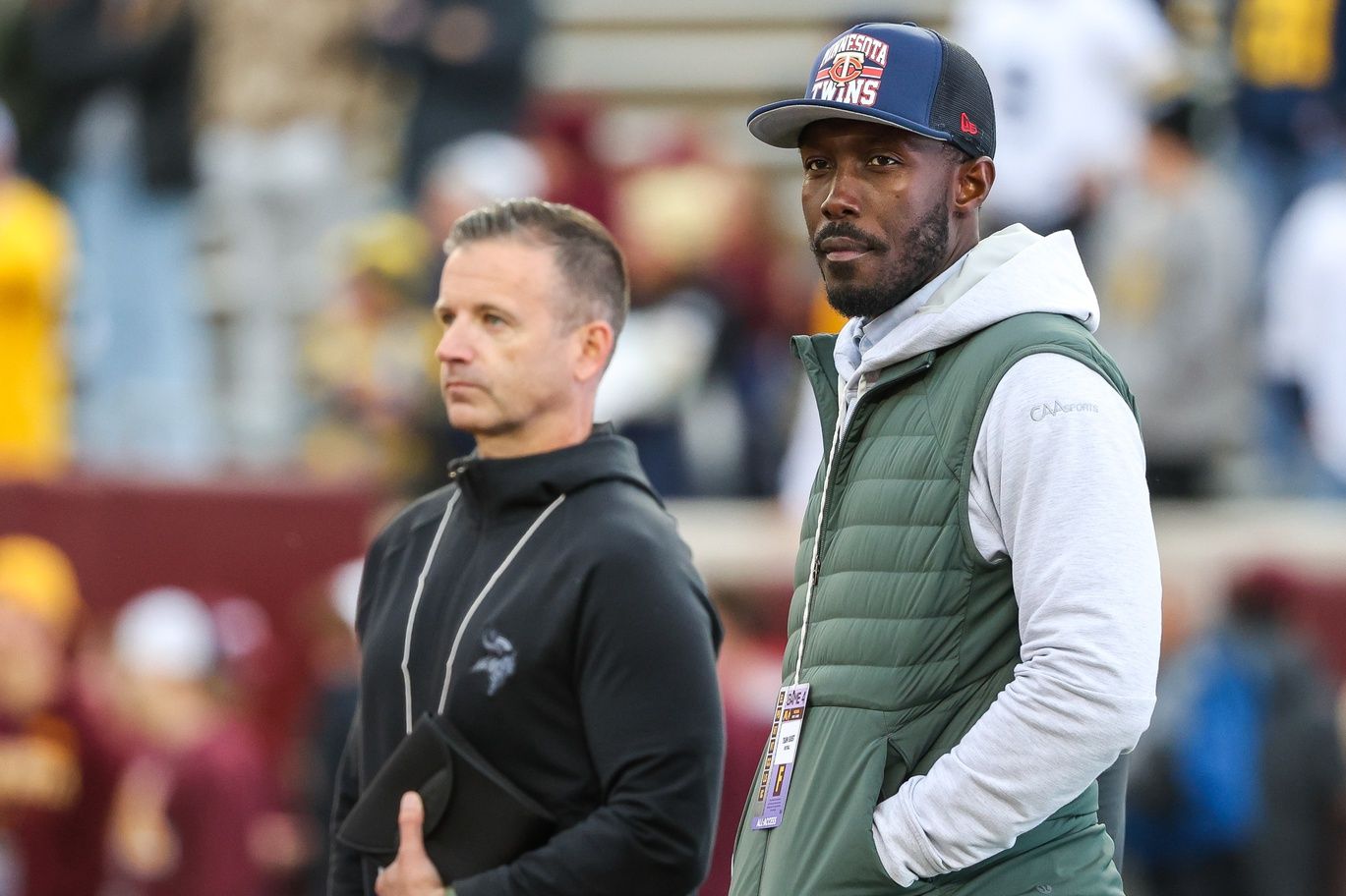 Kwesi Adofo-Mensah stands on the sideline before the Minnesota–Michigan game in Minneapolis.