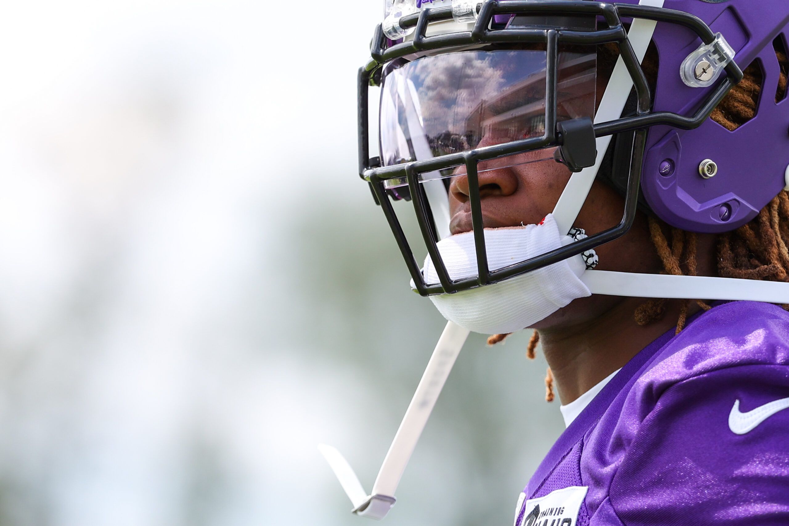 Lewis Cine watches from the field during Vikings training camp at TCO Performance Center.