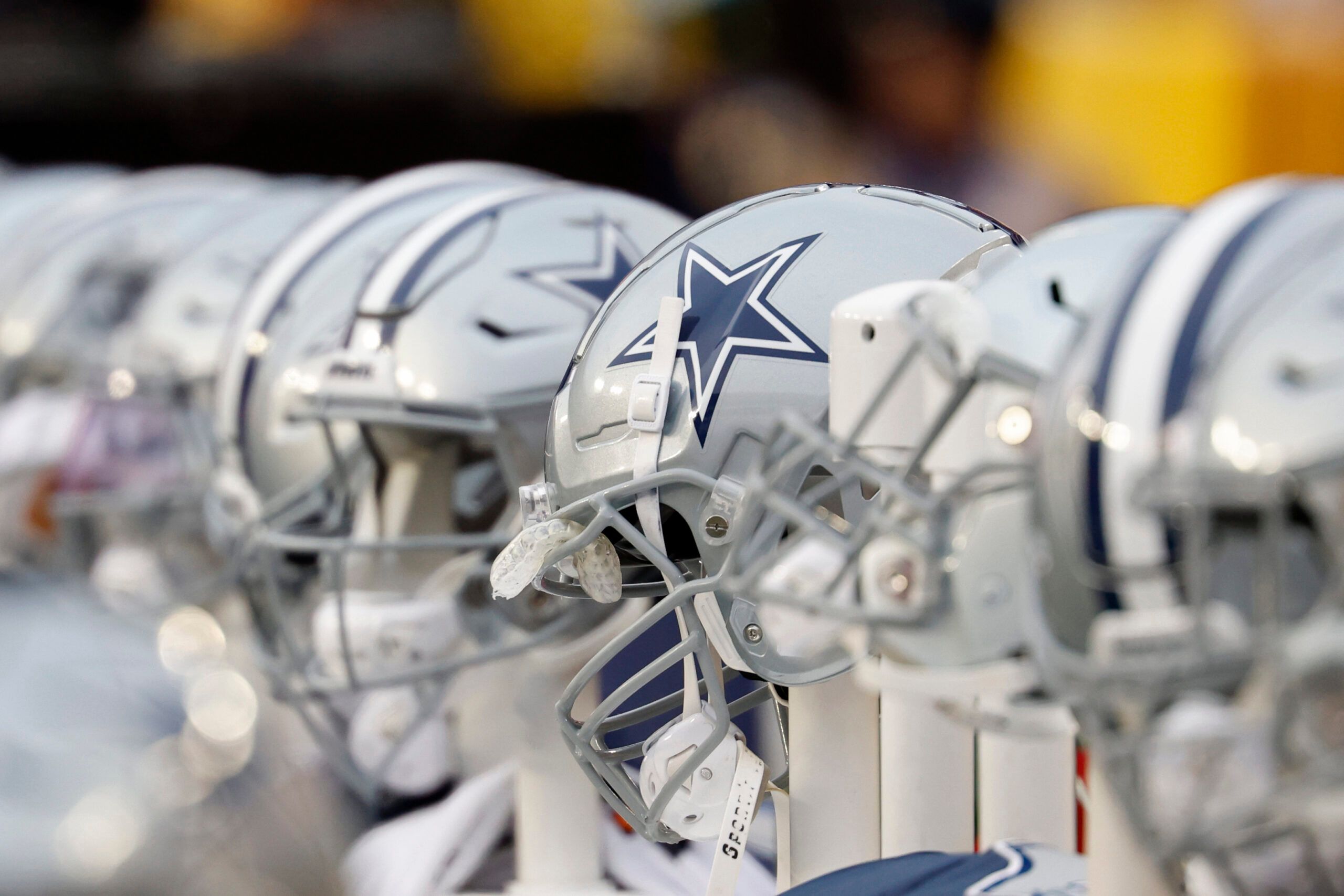 Dallas Cowboys helmets lined up on the bench at FedExField.