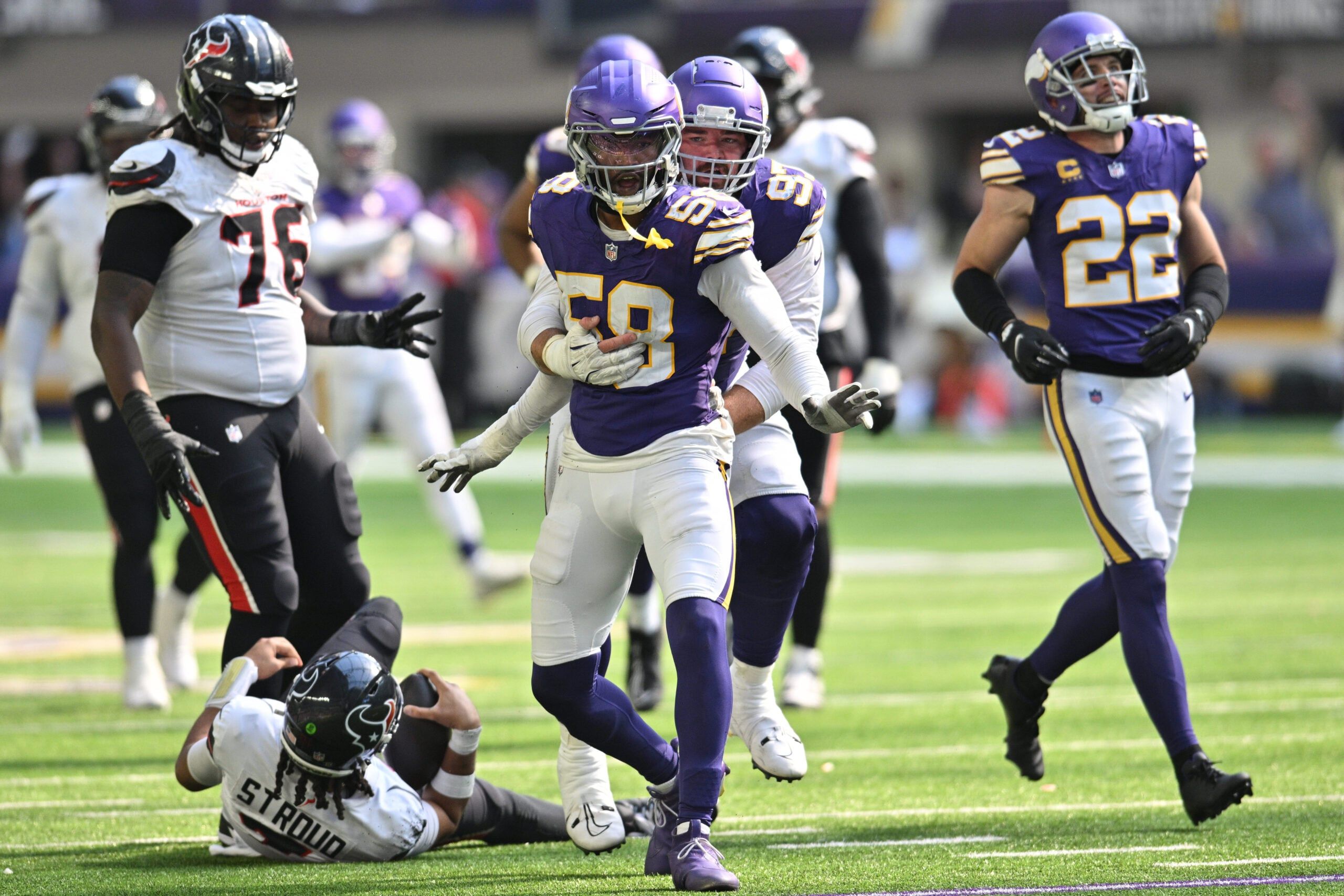 Jonathan Greenard and Harrison Phillips react after a fourth-quarter sack of C.J. Stroud.