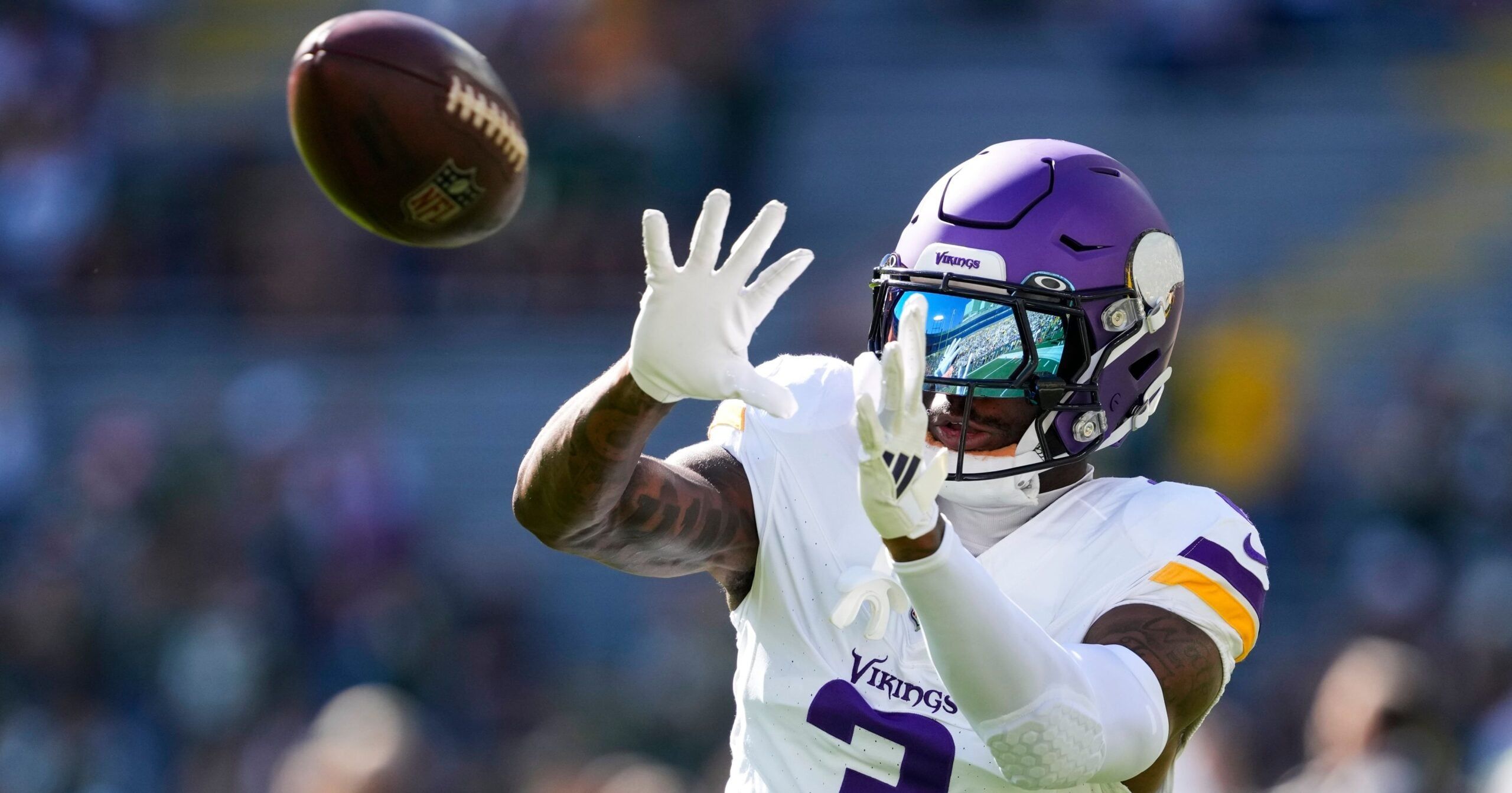 Vikings wide receiver Jordan Addison catches a pass during pregame warmups at Lambeau Field.