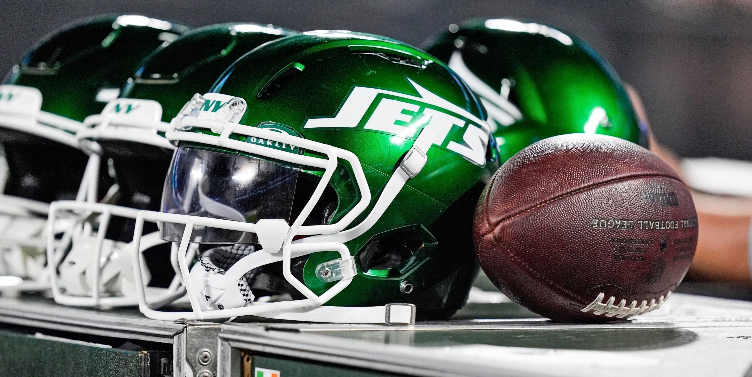 New York Jets helmets sit along the sideline during a preseason game against the Carolina Panthers at Bank of America Stadium.