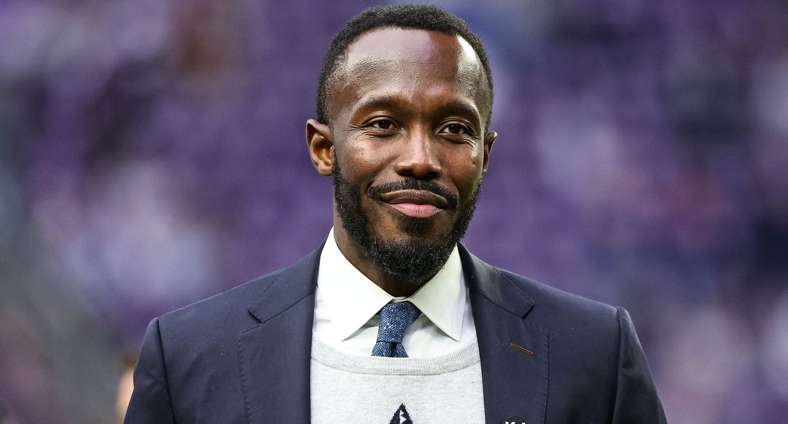 Vikings general manager Kwesi Adofo-Mensah stands on the field at U.S. Bank Stadium before a game against the Falcons.