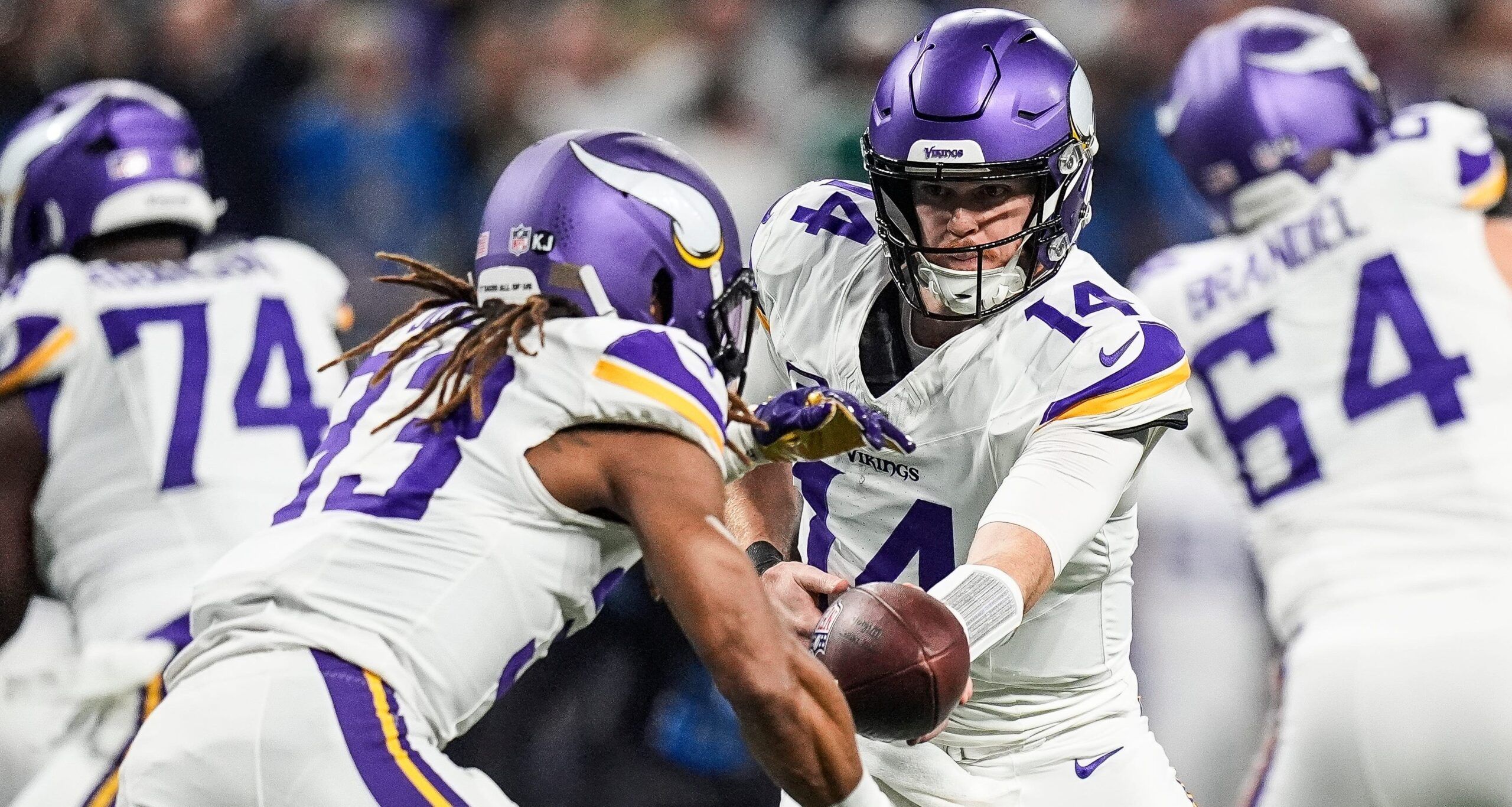 Sam Darnold hands off to Aaron Jones during the Vikings’ game against the Lions at Ford Field.