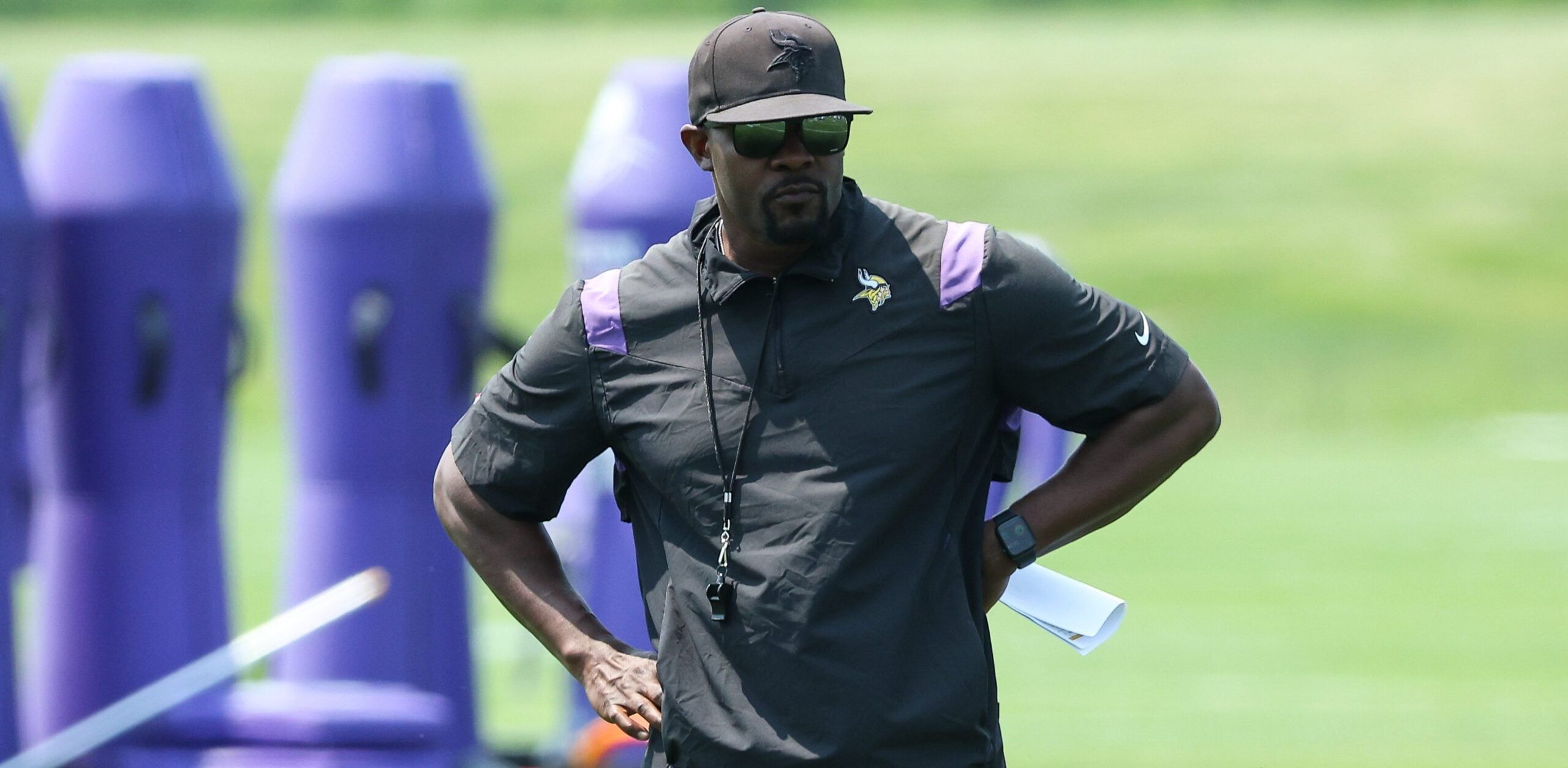 Vikings defensive coordinator Brian Flores watches practice during Minnesota minicamp at the team training facility.