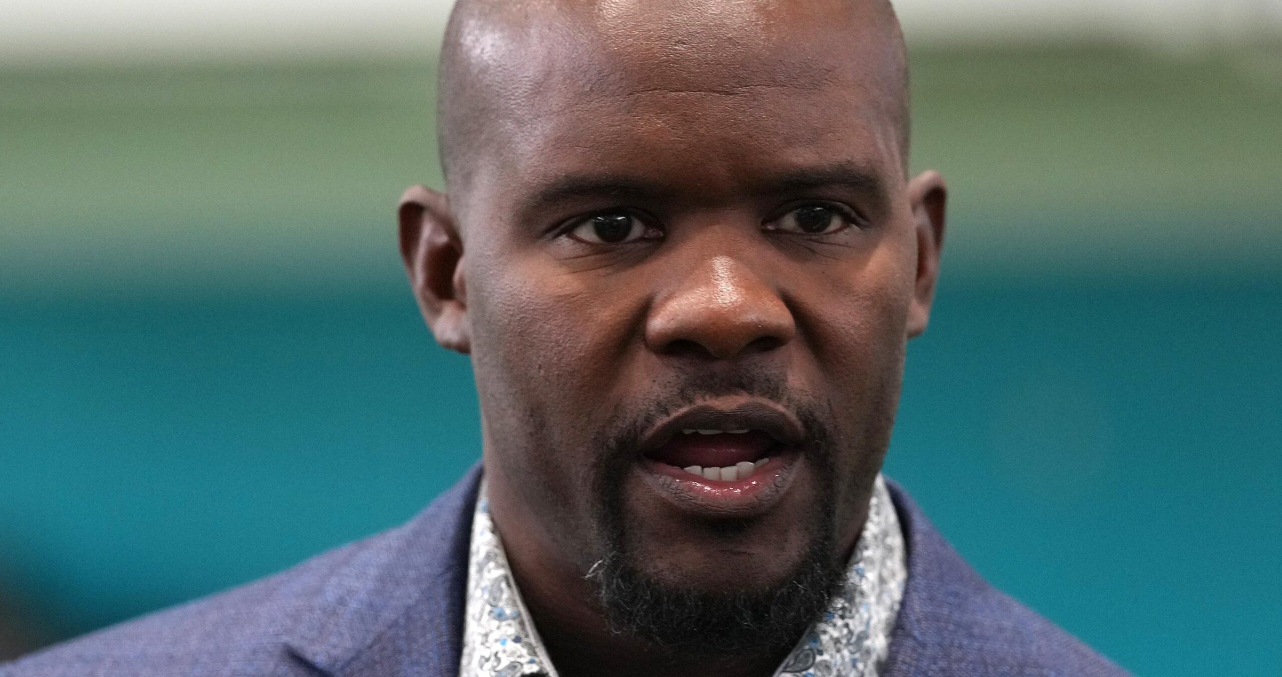 Brian Flores talks with attendees during the grand opening at the Dolphins’ Baptist Health Training Complex.