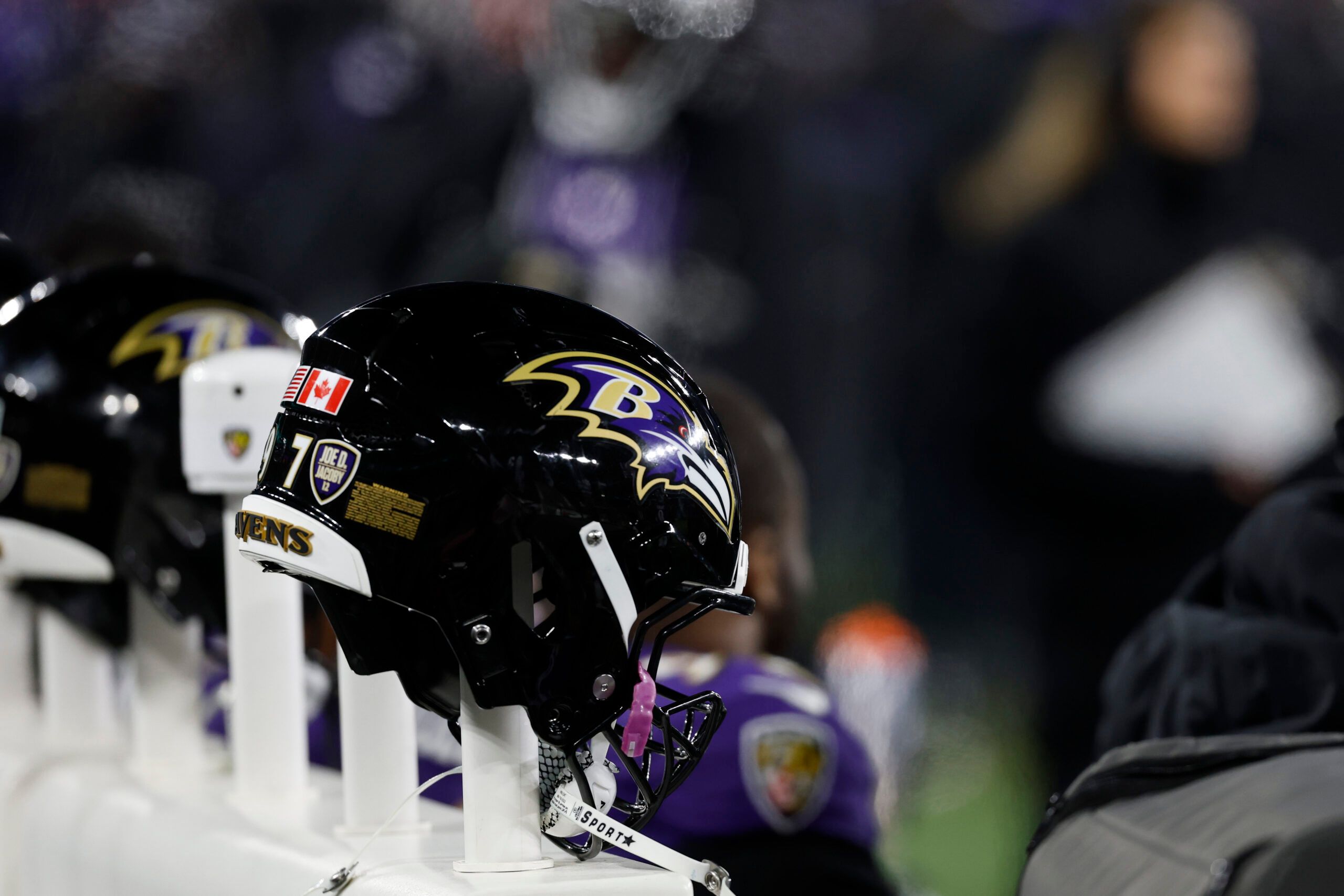 Baltimore Ravens helmets on a heated bench during a playoff game