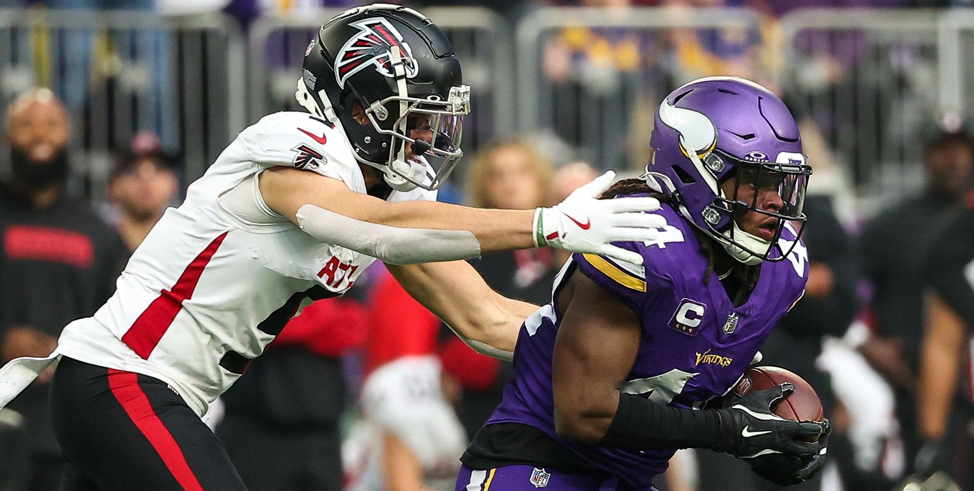 Vikings safety Josh Metellus and Falcons WR Drake London in 2024.