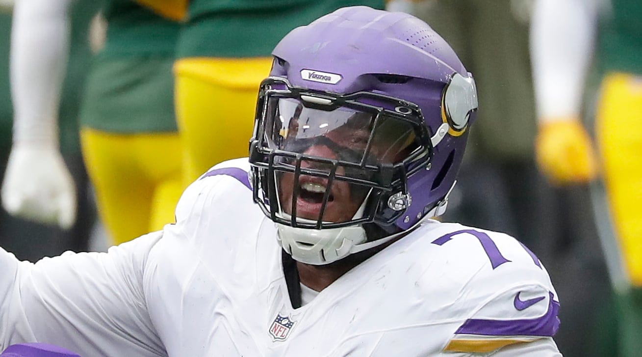Micah Parsons helps Christian Darrisaw off the ground during a game at Lambeau Field.