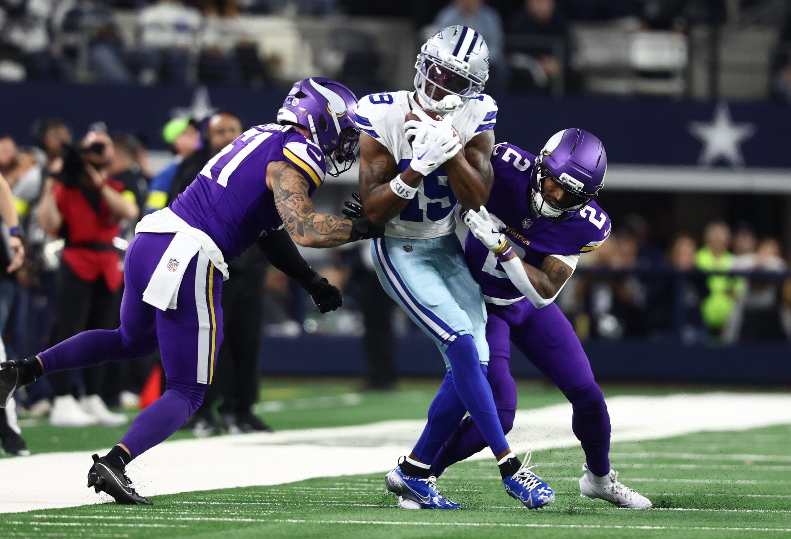 Blake Cashman and Isaiah Rodgers tackle Ryan Flournoy during a game against the Cowboys