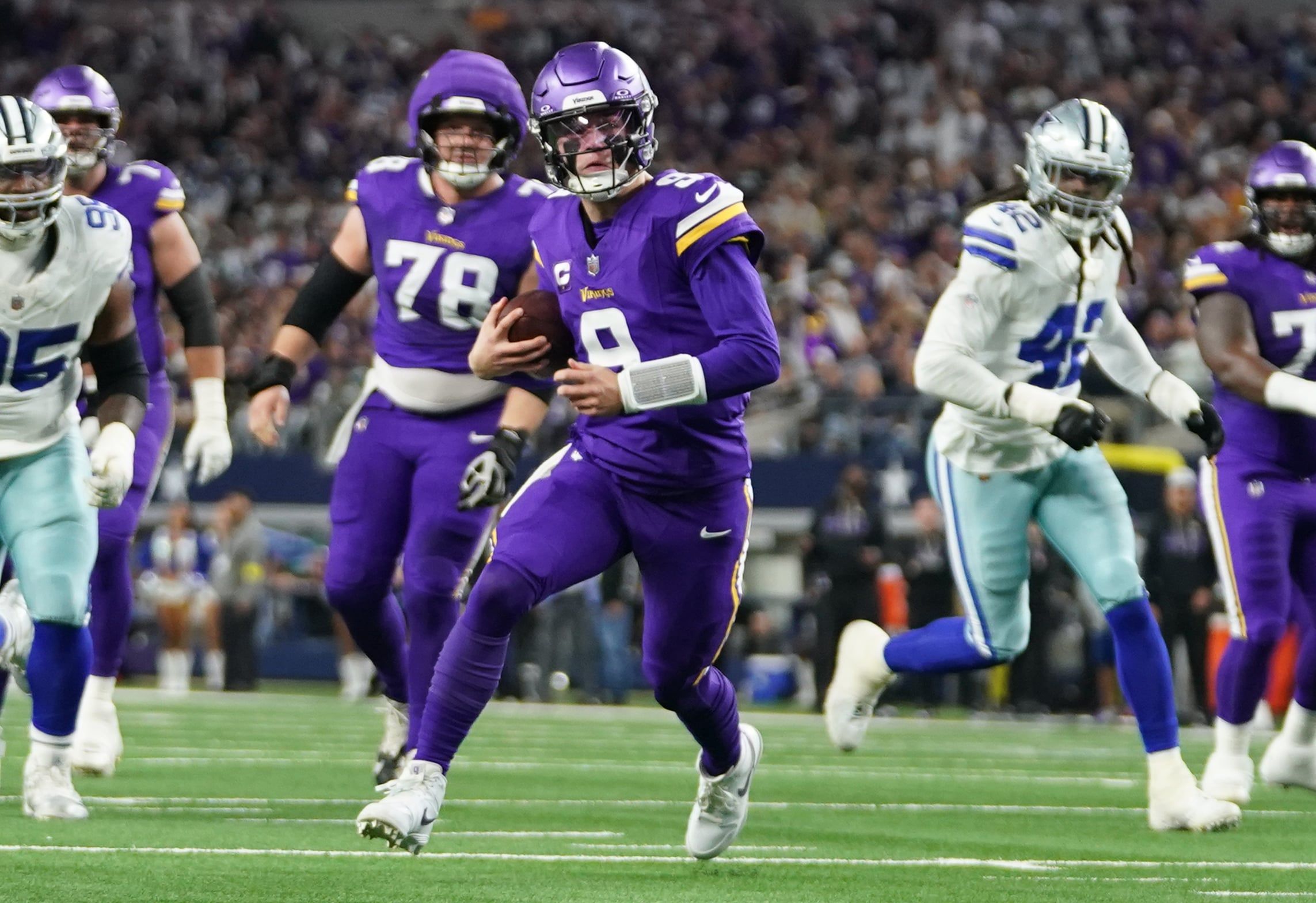 J.J. McCarthy scrambles outside the pocket during a Vikings road game against the Dallas Cowboys at AT&T Stadium.
