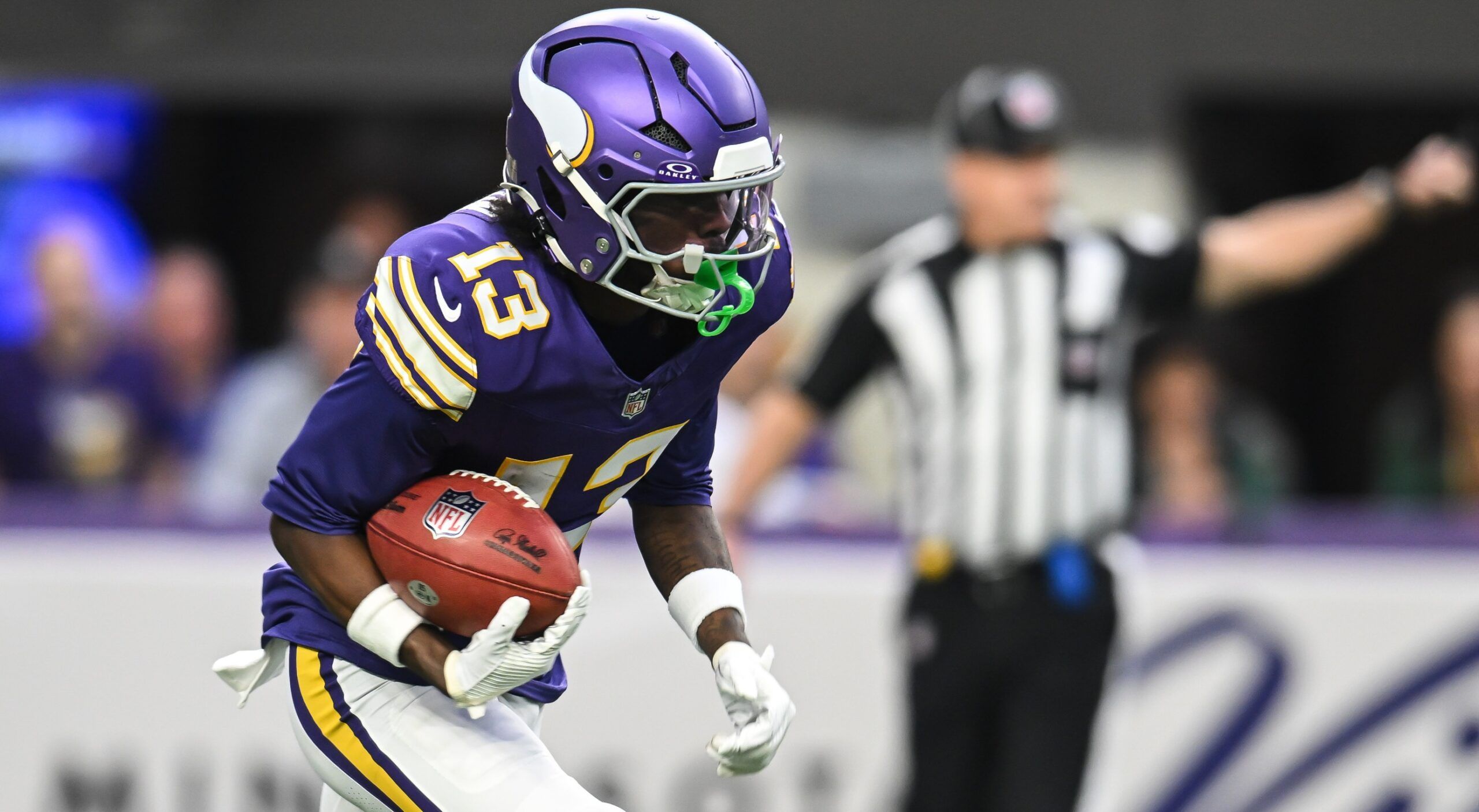 Vikings wide receiver Tai Felton returning the ball against the Packers at U.S. Bank Stadium