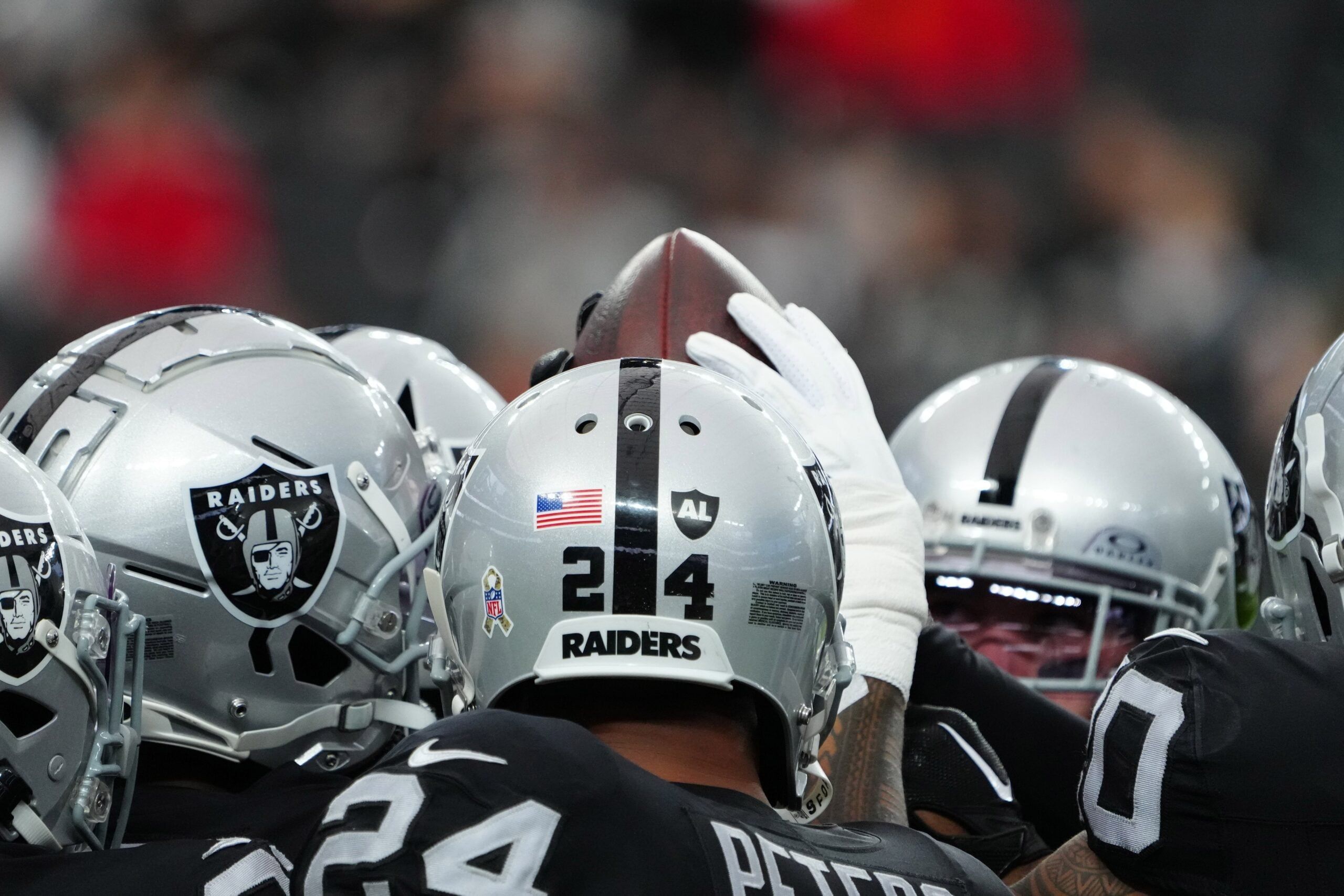 A Las Vegas Raiders huddle in 2023.