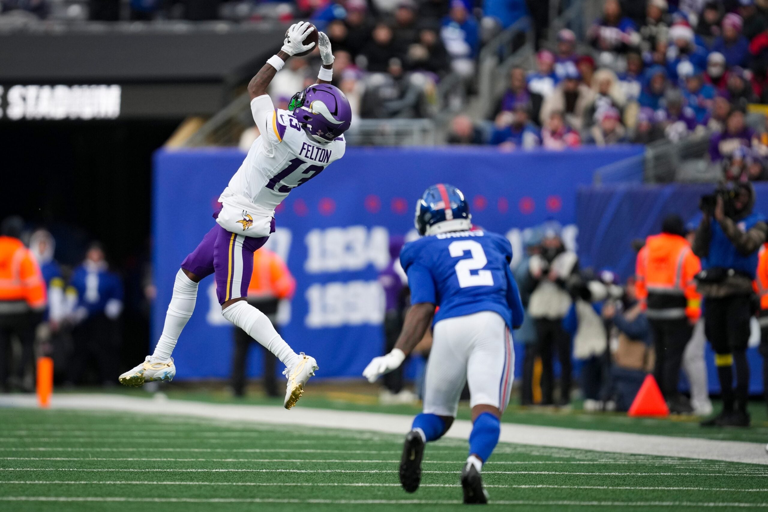 Tai Felton catches a pass while defended by Deonte Banks at MetLife Stadium.