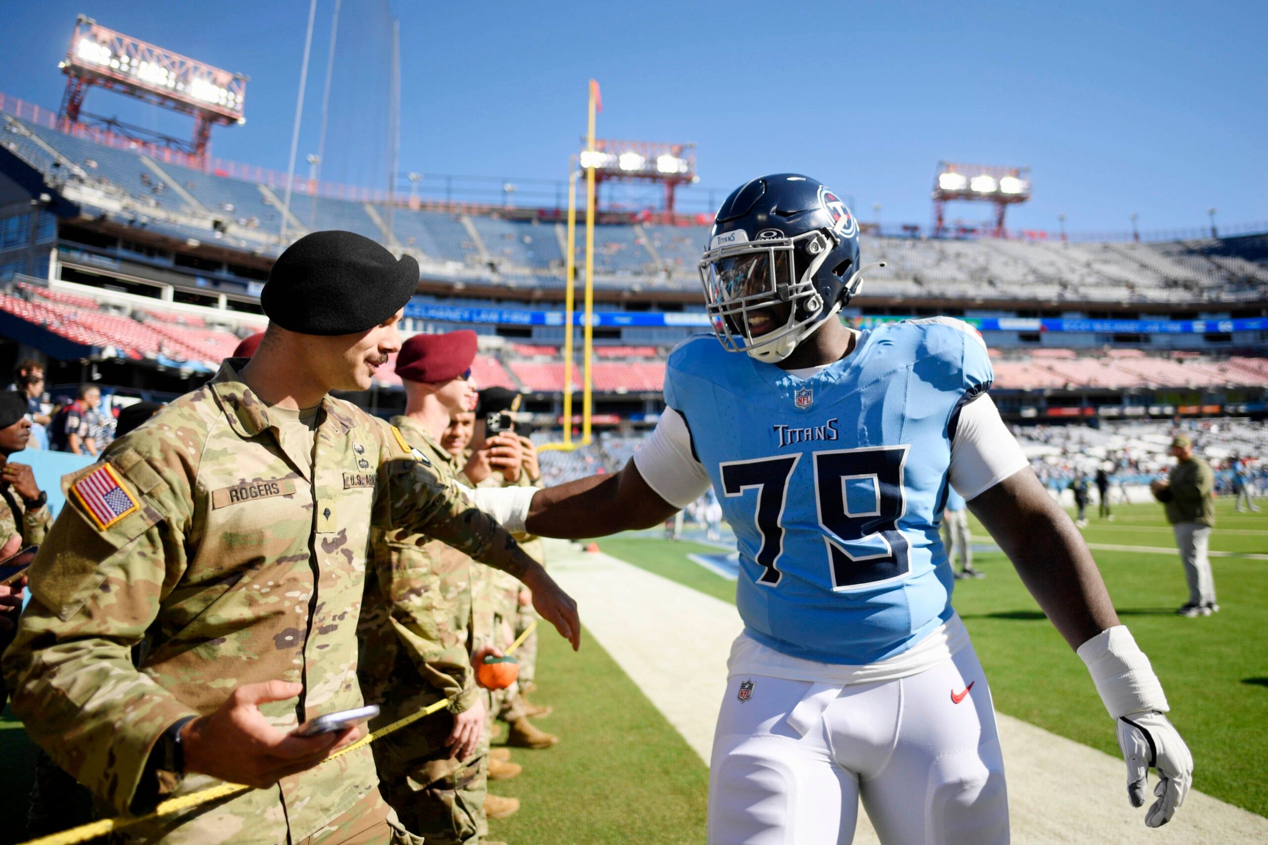 Lloyd Cushenberry III greets a military member before a game at Nissan Stadium.