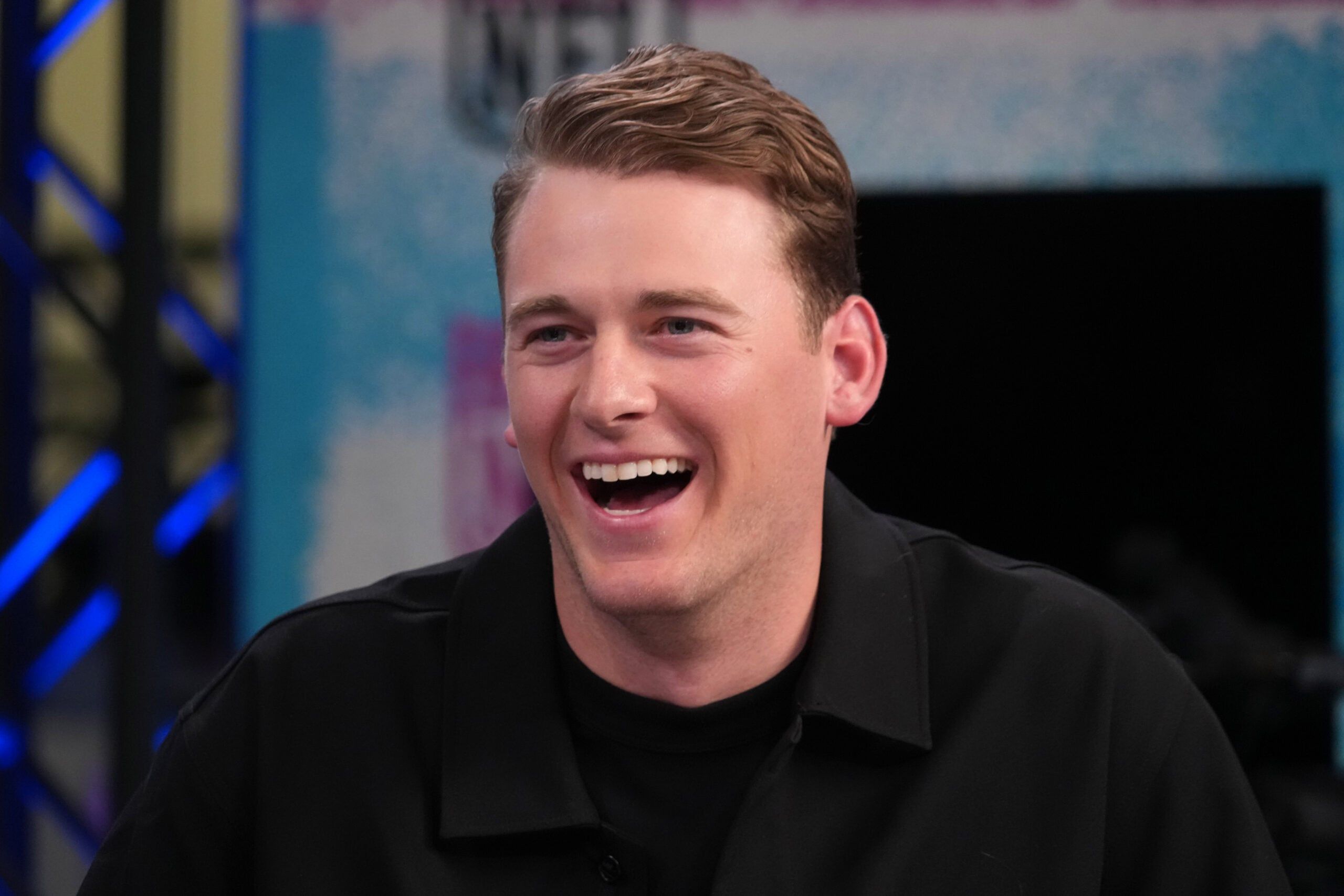 Mac Jones sits on the NFL Network set during Super Bowl media week at the Moscone Center in San Francisco.