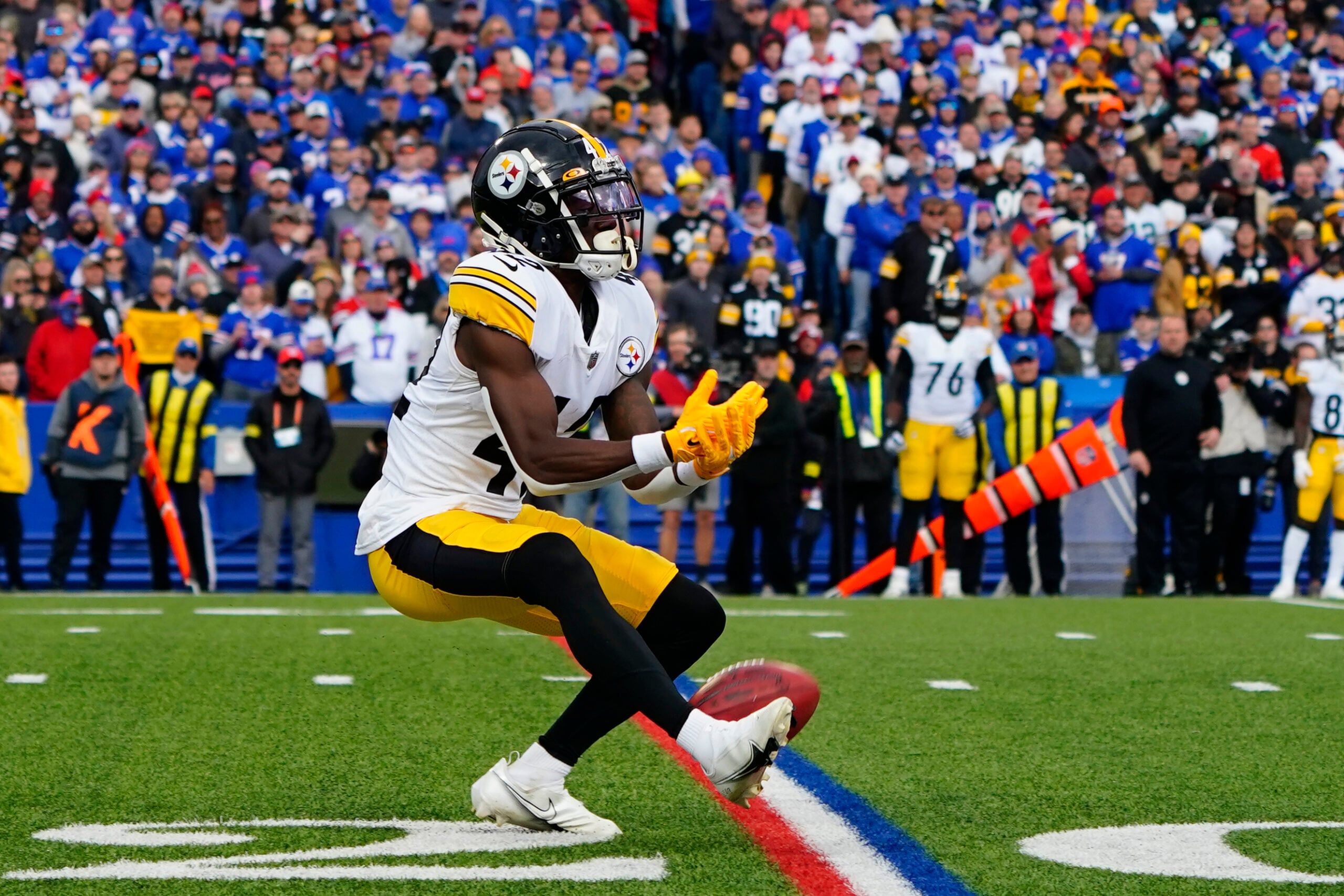 James Pierre fumbling a punt while Bills players close in during a Steelers game