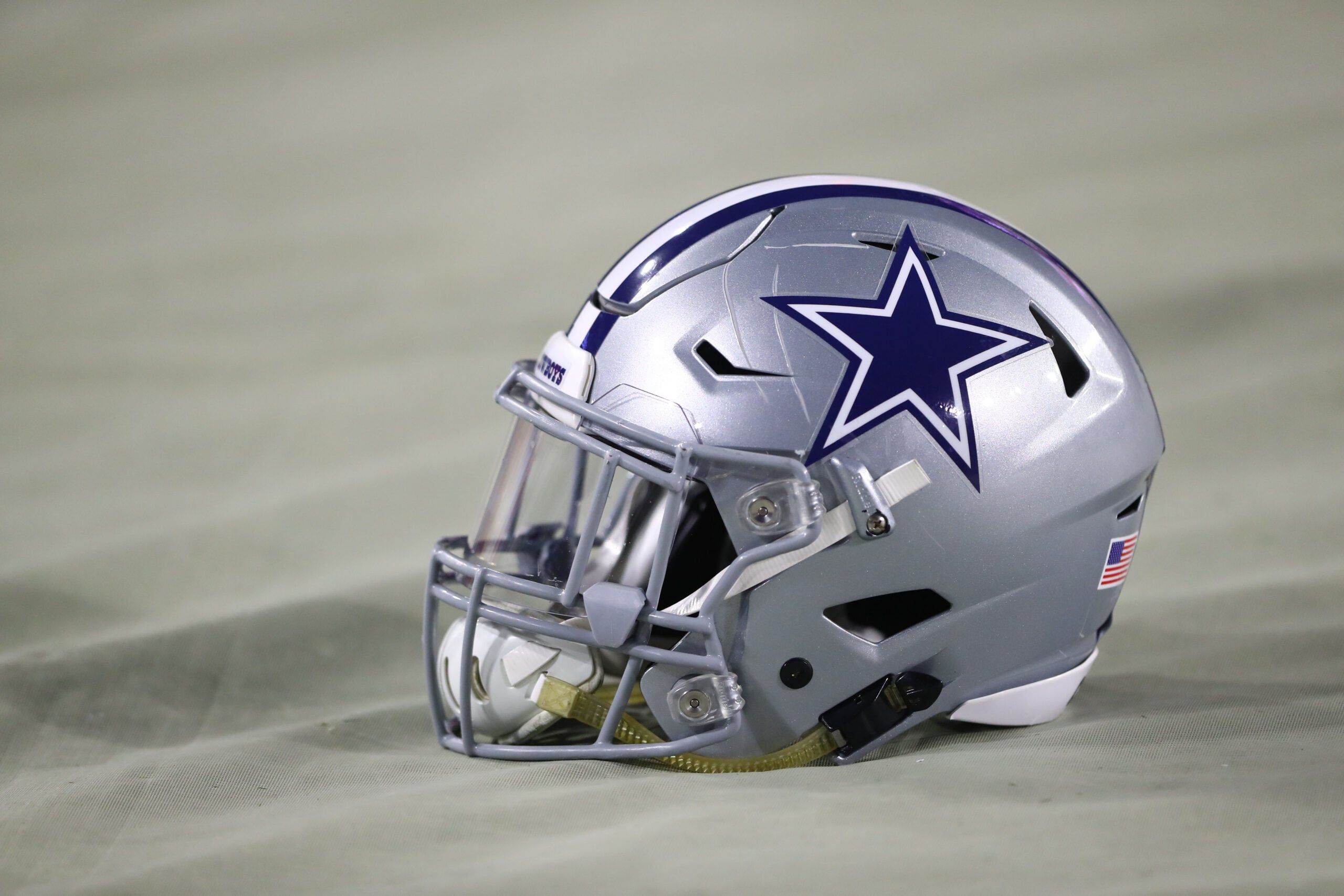 A Cowboys helmet on the field in 2017 before a game against the Cardinals