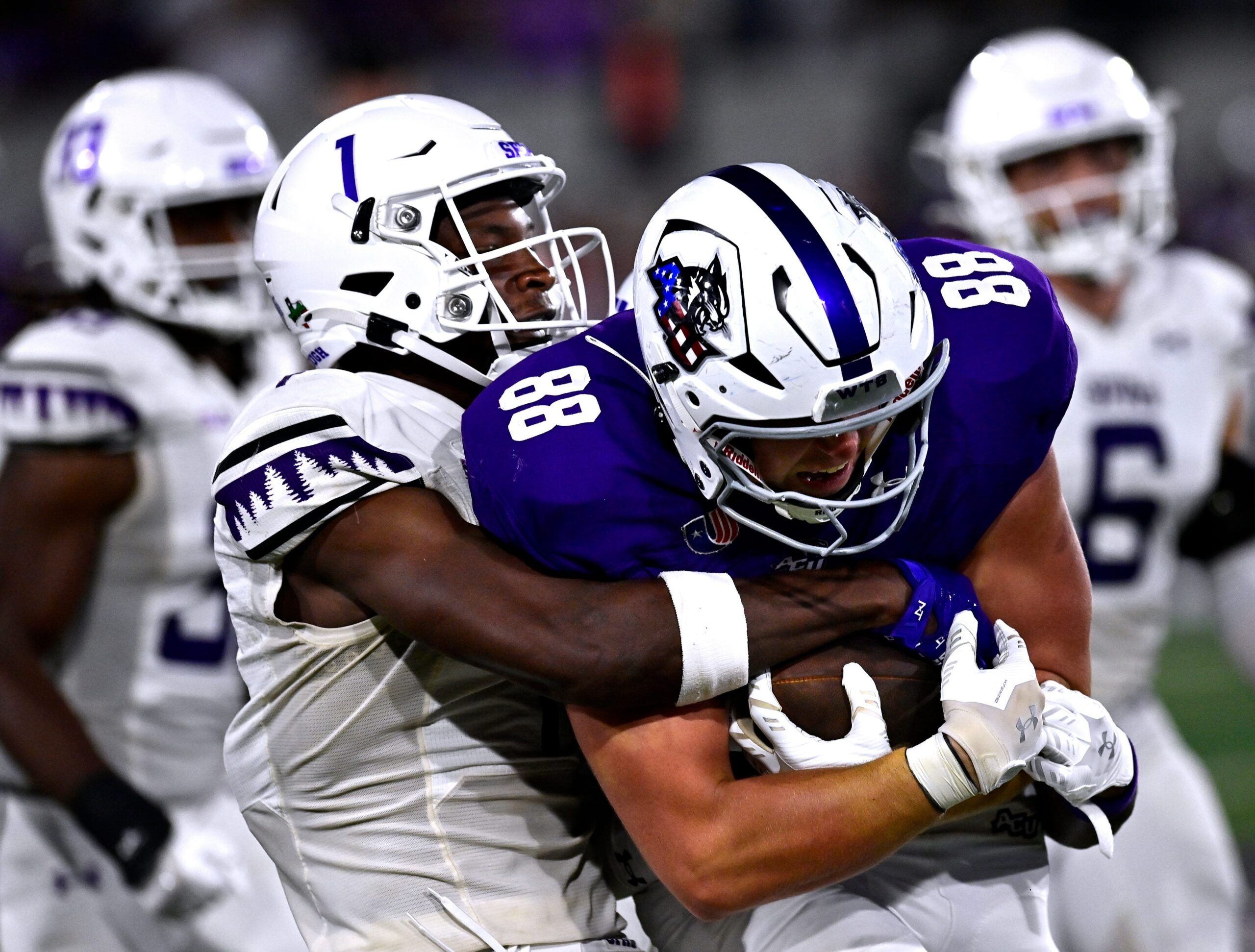 Charles Demmings tackles Jed Castles during a college football game between SFA and Abilene Christian.