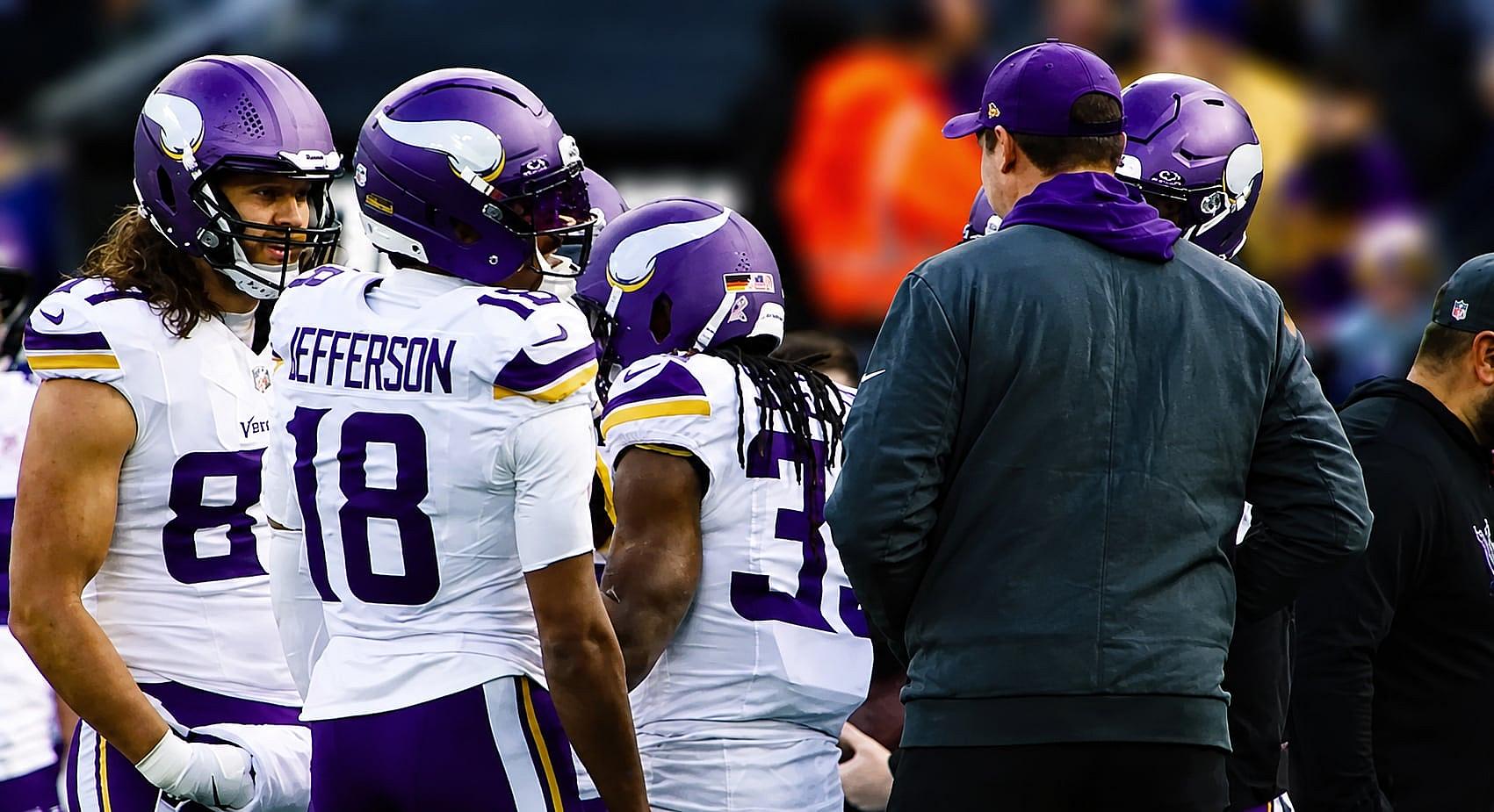 T.J. Hockenson and Justin Jefferson stand together on the Vikings sideline.