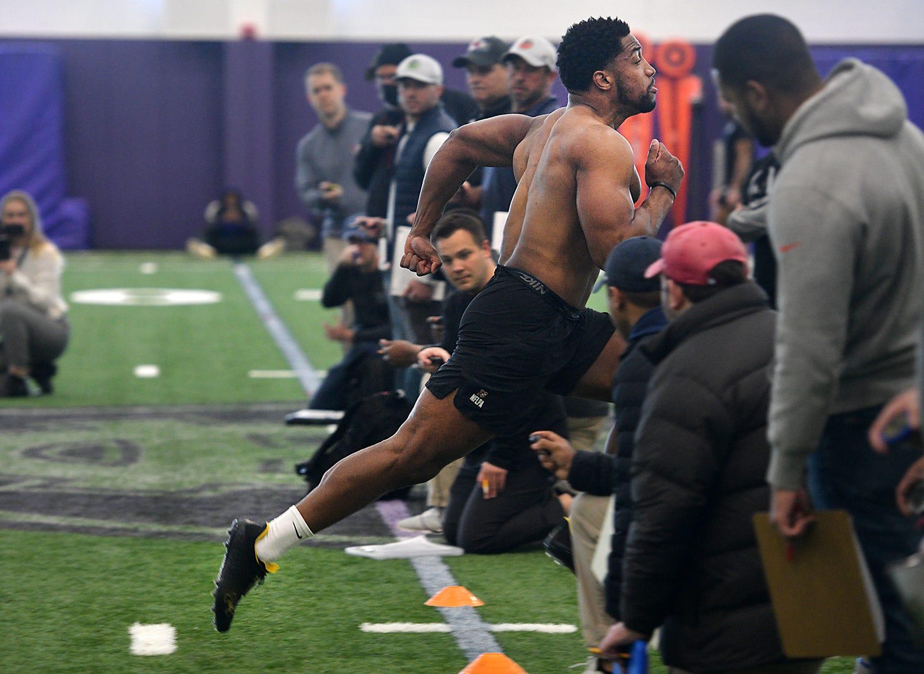 Benton Whitley participates in a timed running drill during a pro day workout at the Luth Center indoor football facility in Worcester.