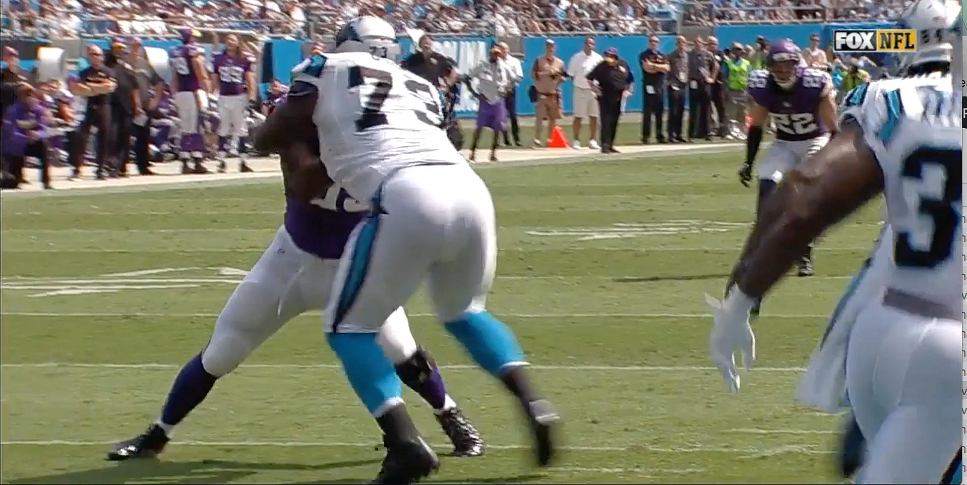 Vikings player in purple jersey evading defender in blue during game.