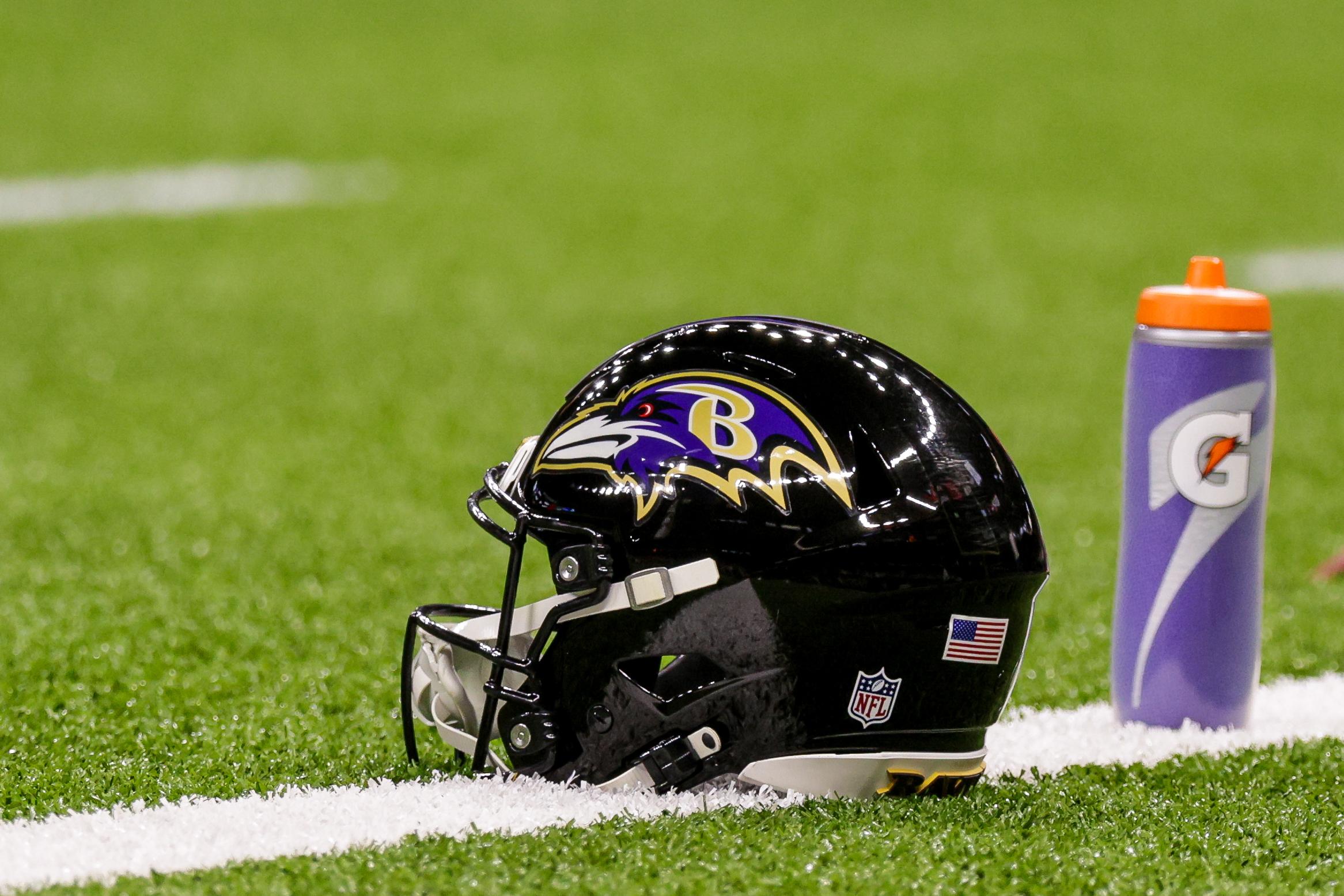 A Baltimore Ravens helmet rests on the field before a game against the New Orleans Saints at Caesars Superdome.