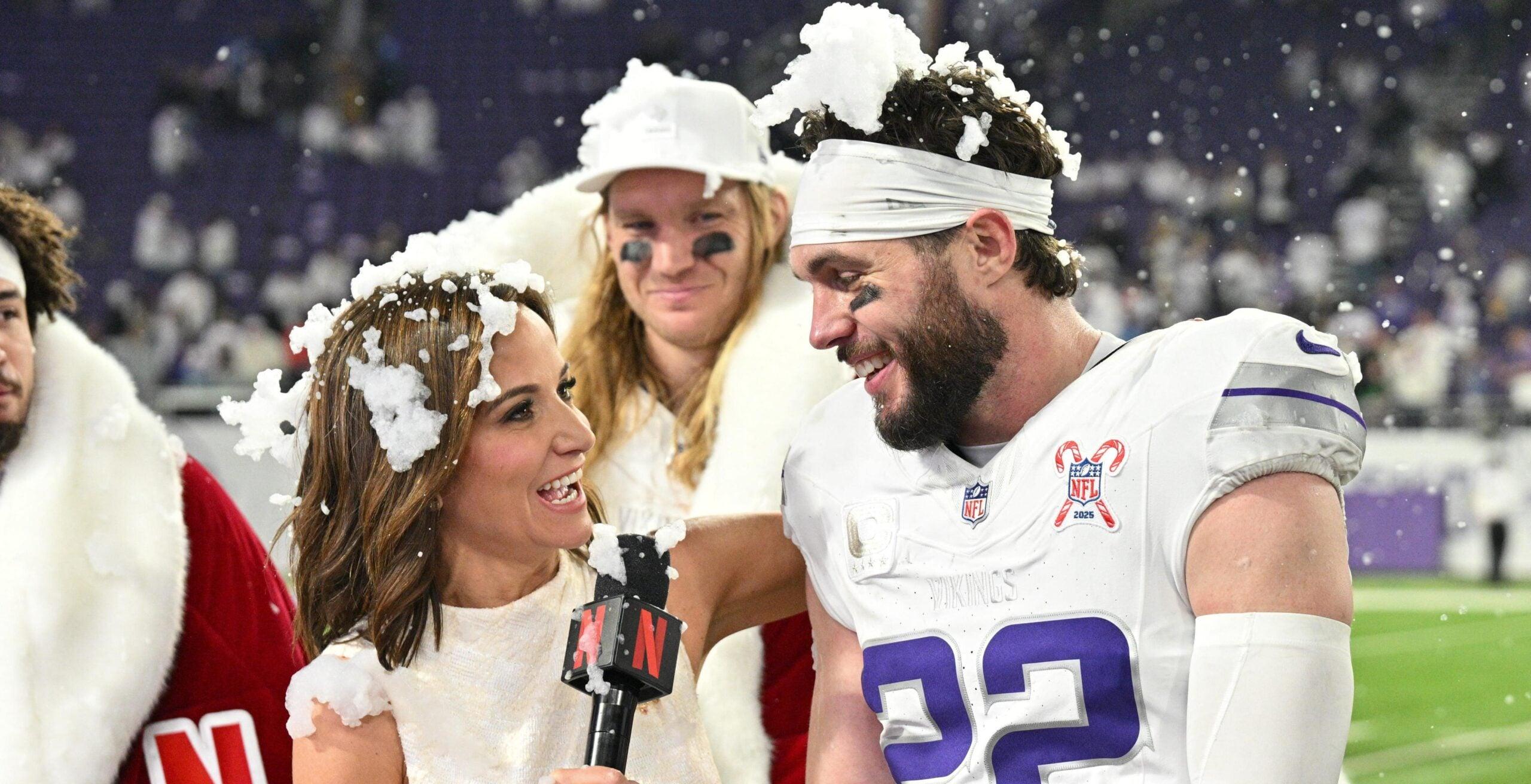 Vikings defenders speak with Seth Rollins and Dianna Russini after a game against the Lions at U.S. Bank Stadium.