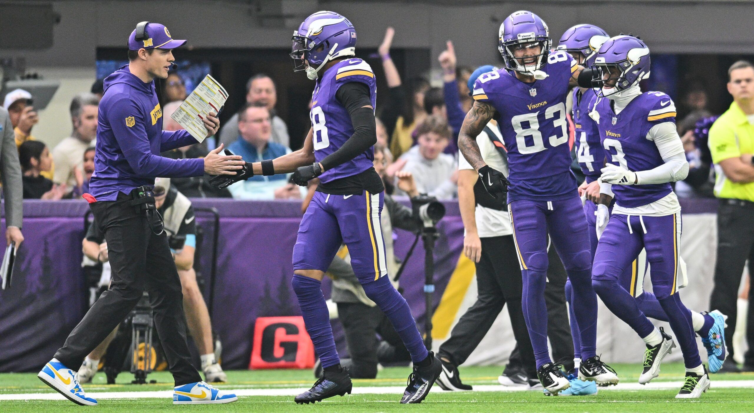 Kevin O’Connell celebrates with Jefferson, Nailor, and Addison after Vikings touchdown vs. Falcons.