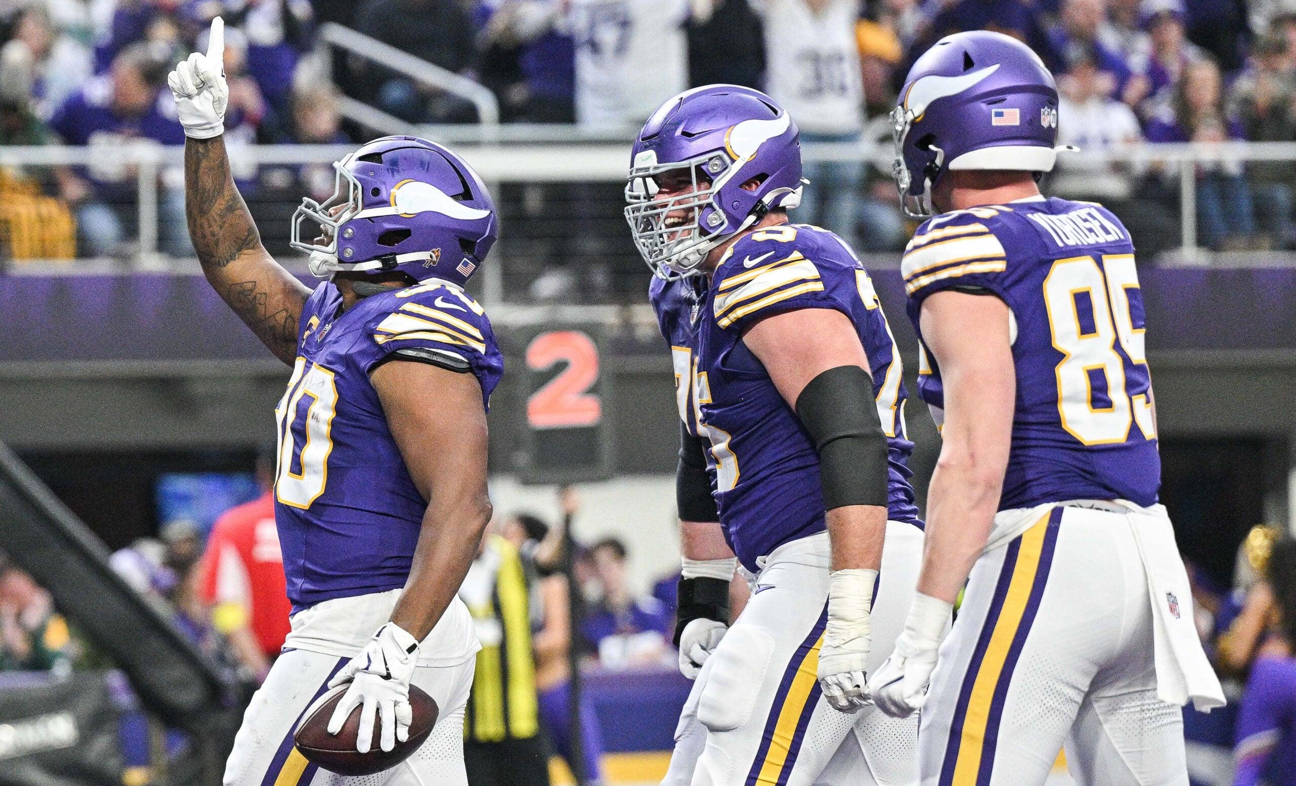 C.J. Ham, Brian O'Neill, and Ben Yurosek celebrate a Vikings touchdown during a game against the Packers at U.S. Bank Stadium.