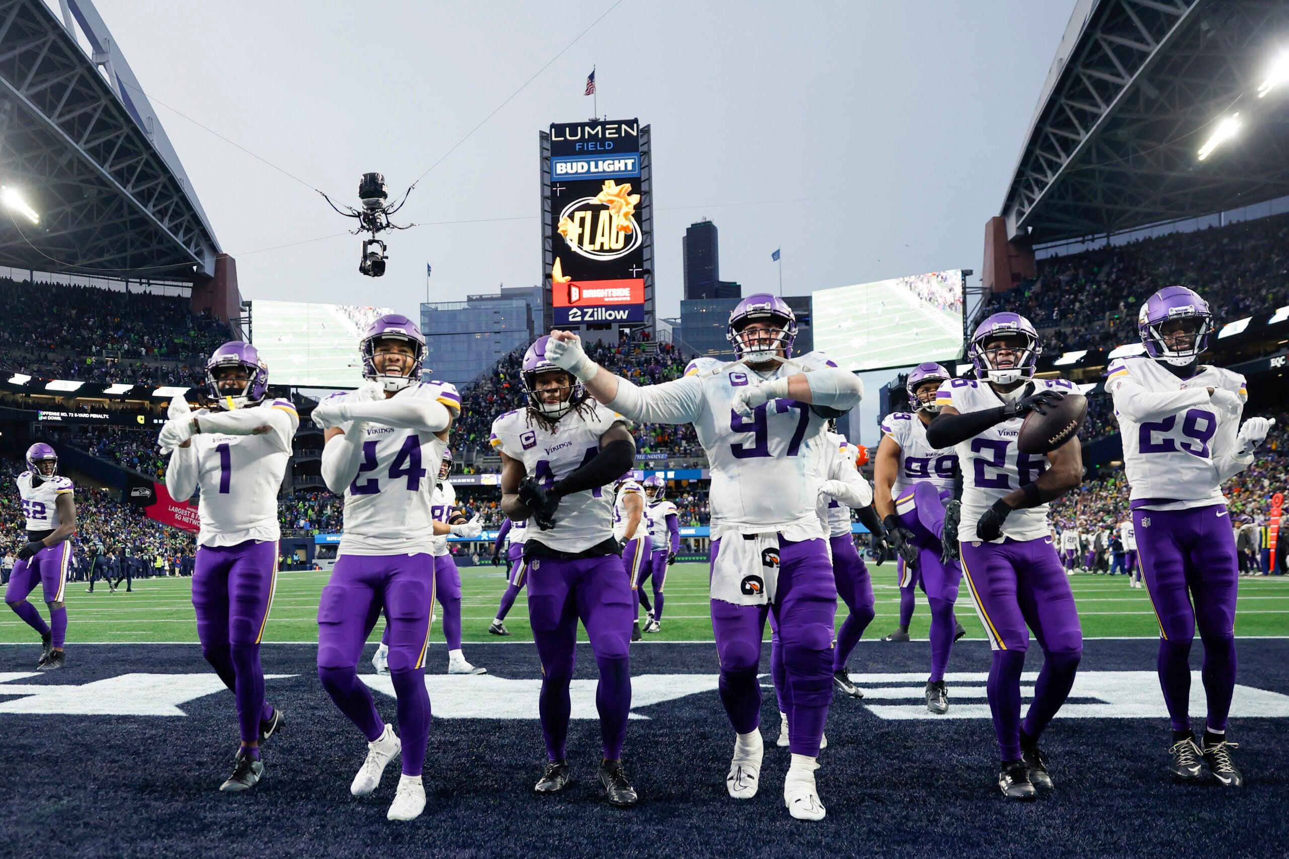 Theo Jackson celebrates an interception with Vikings teammates during a game against the Seahawks.