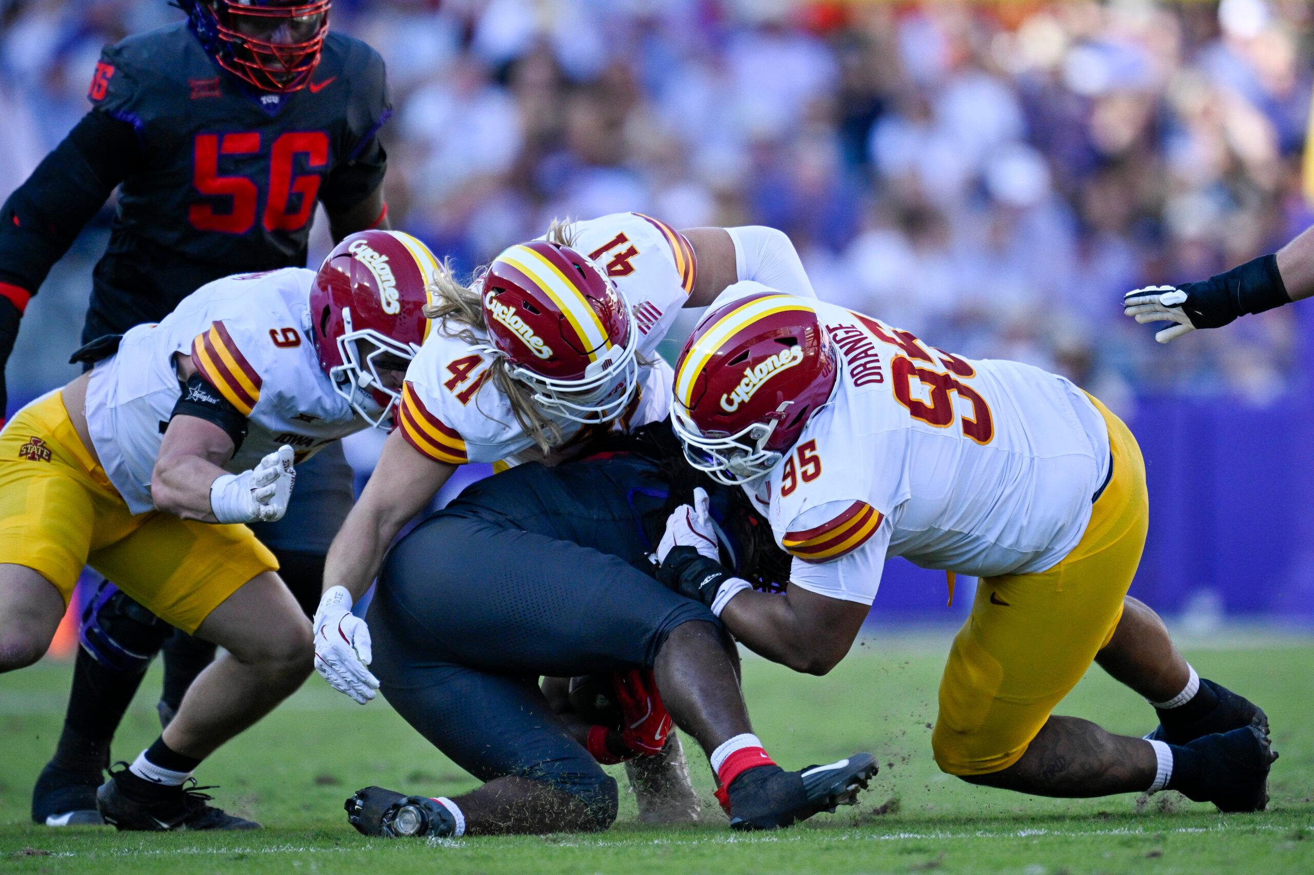 TCU running back Kevorian Barnes is tackled by multiple Iowa State defenders during a game at Amon G. Carter Stadium in Fort Worth.