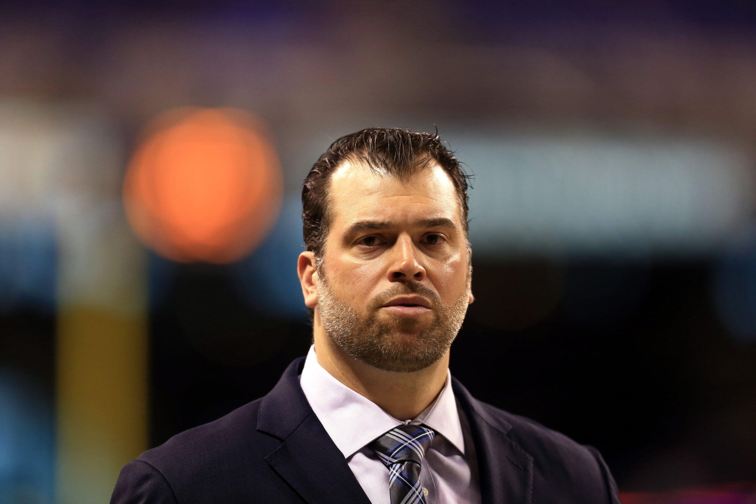 Ryan Grigson stands on the field before the Colts' AFC Wild Card game against the Bengals.