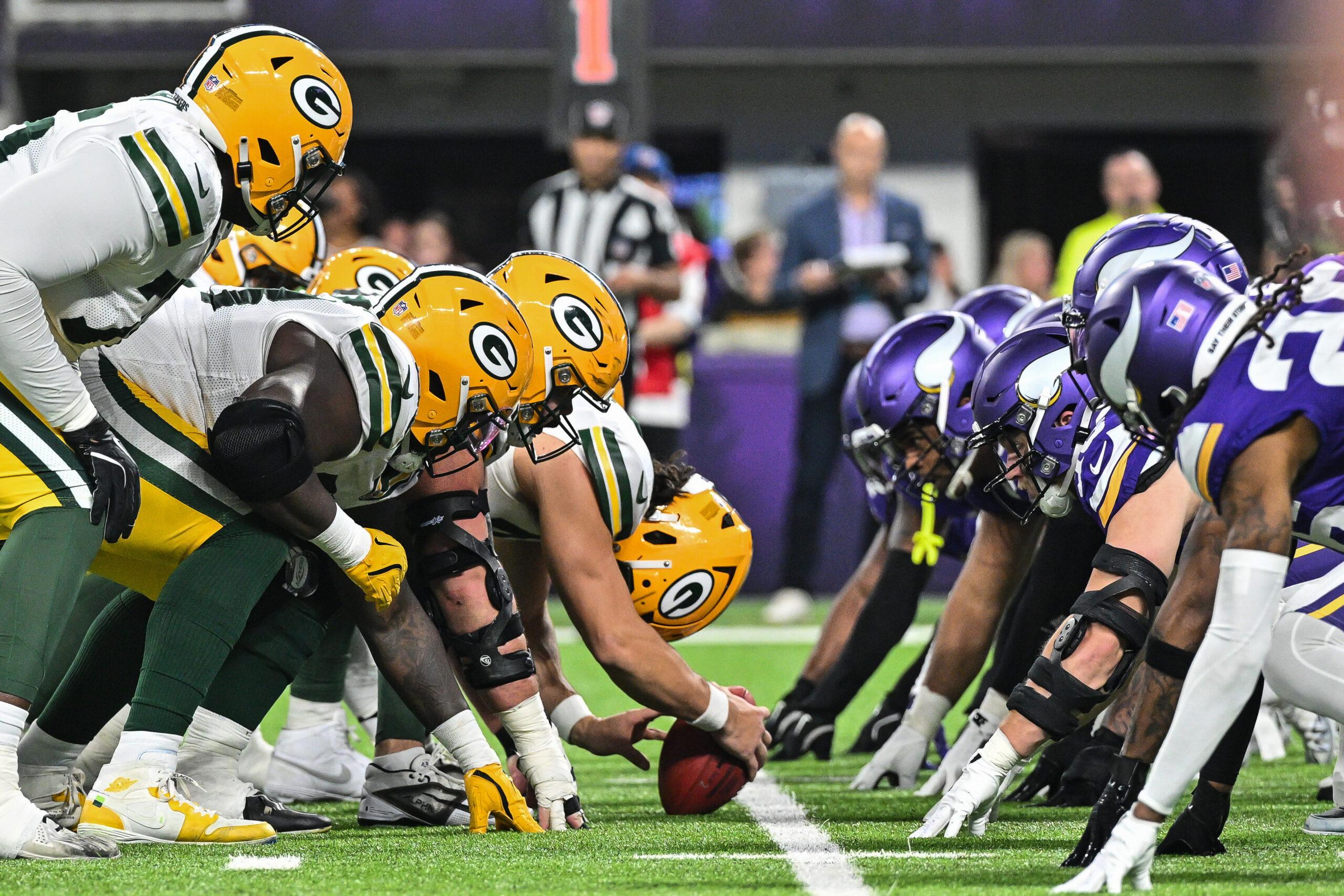 The Vikings and Packers line up at the line of scrimmage during a game at U.S. Bank Stadium.