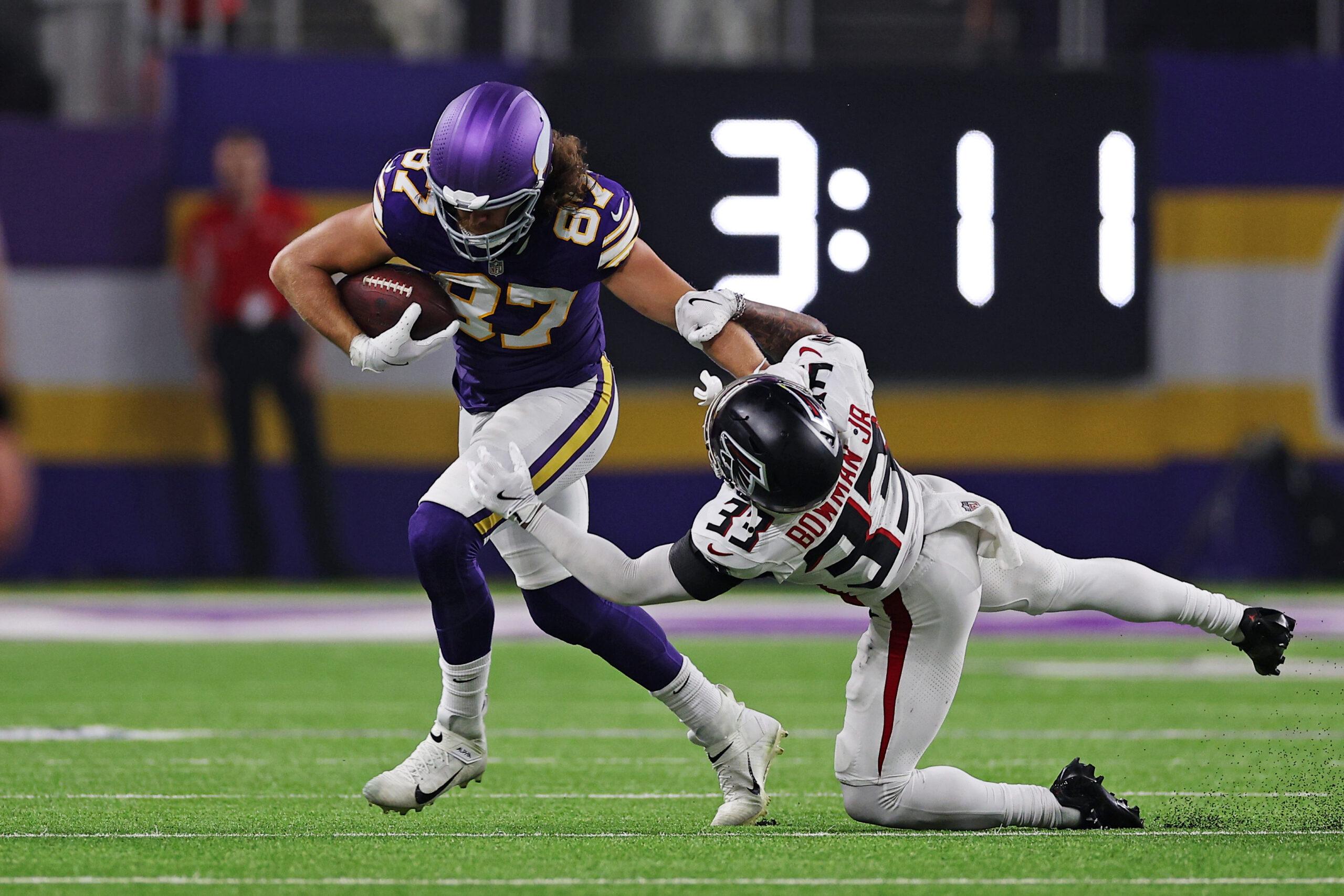 T.J. Hockenson runs after a catch against Falcons safety Billy Bowman Jr.