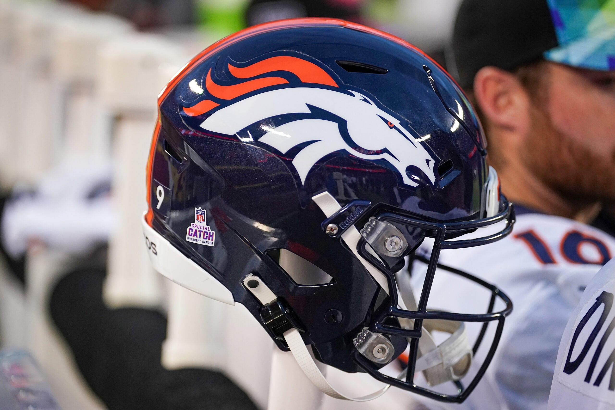 Denver Broncos helmet sits on the field before a game against the Chiefs.