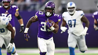 Vikings running back carries the football during home game against opposing team.