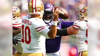 Vikings player in purple jersey celebrates during game against 49ers opponents.