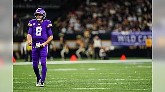 Vikings player number 8 in purple jersey on football field during game.