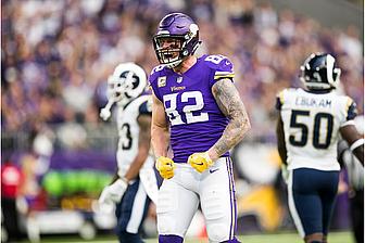 Vikings player number 52 in purple jersey celebrates during NFL game.