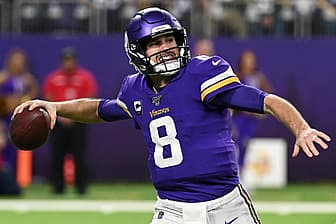 Vikings quarterback number 8 throwing football during game in purple jersey.