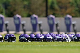 Vikings helmets in Eagan, MN. Vikings roster battles heat up at training camp.