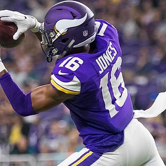 Vikings player wearing purple jersey number 16 catching football.