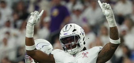 Vikings linebacker Dallas Turner celebrates while Lions quarterback Jared Goff reacts after a defensive play at U.S. Bank Stadium.