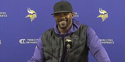 Brian Flores speaks with reporters at the TCO Performance Center during the 2024 Vikings season.